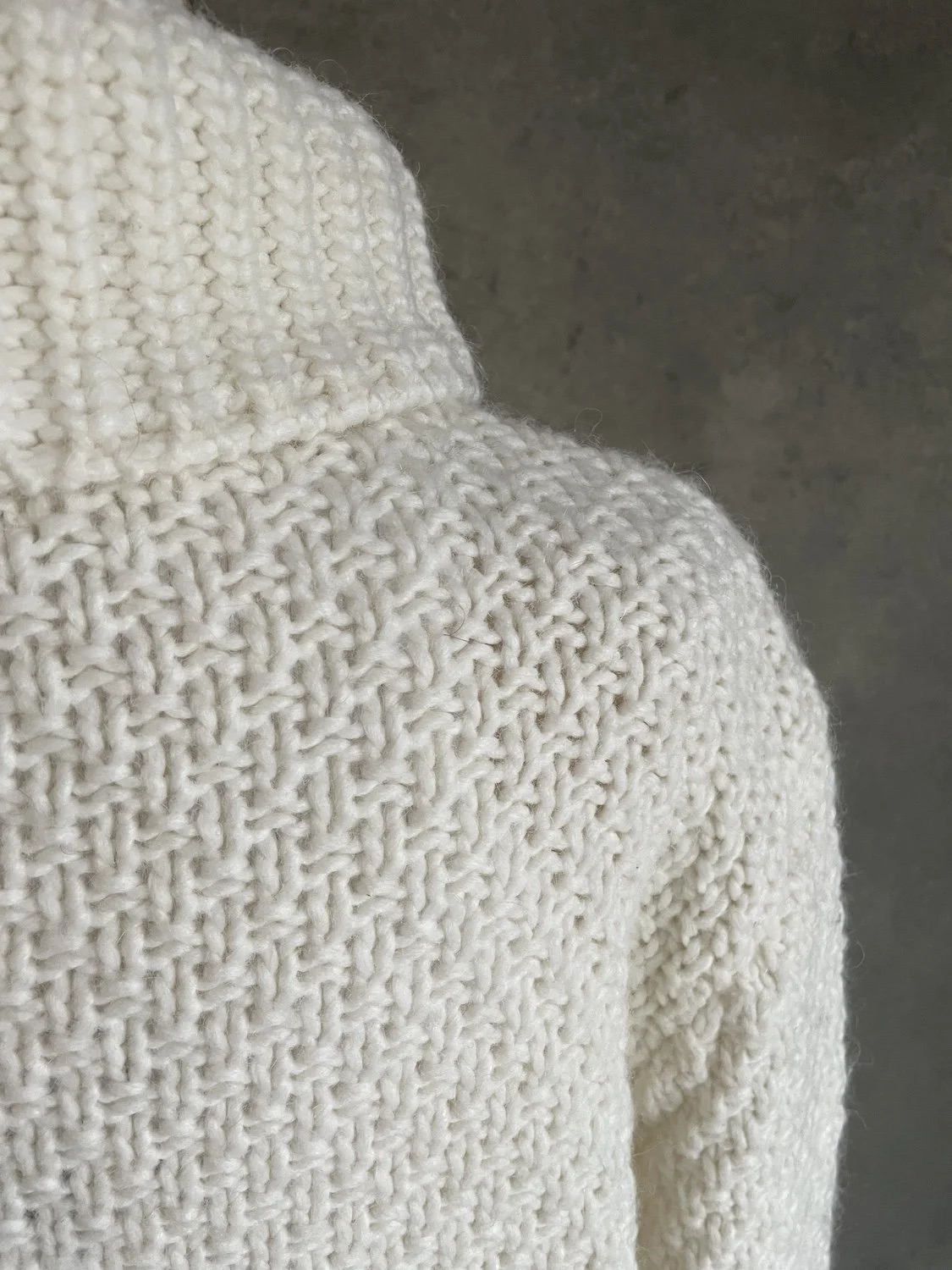Back shoulder and upper back textured knit detail.