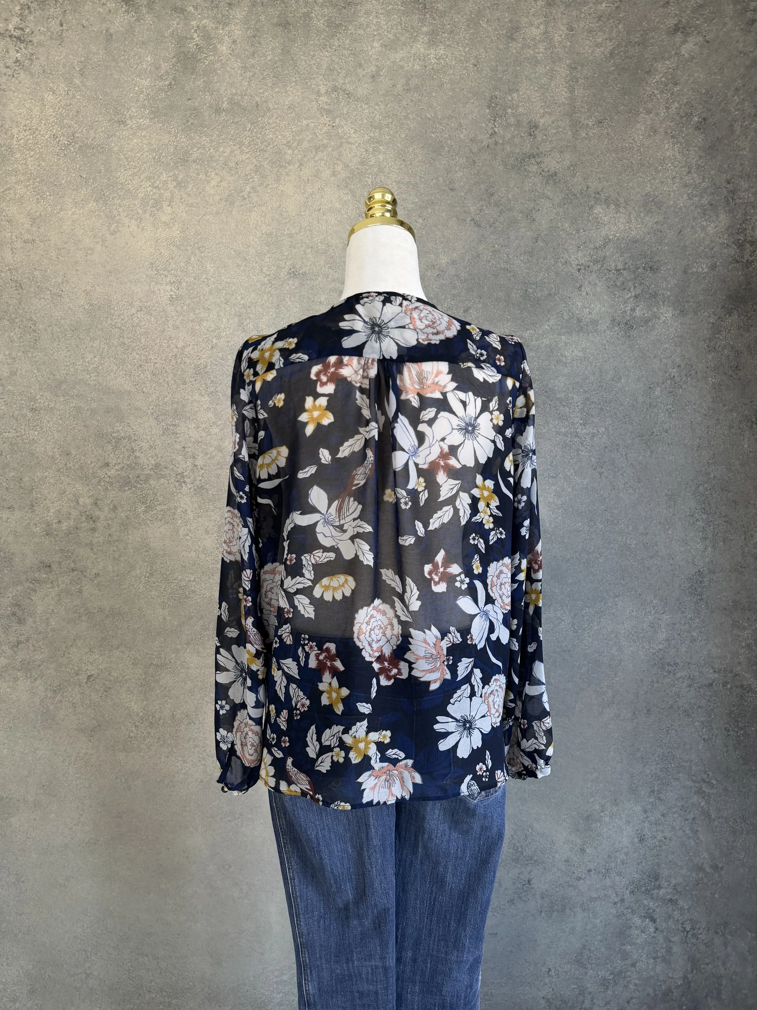 Full back view of the Gigue floral navy blouse, emphasizing the consistent pattern and clean, classic design