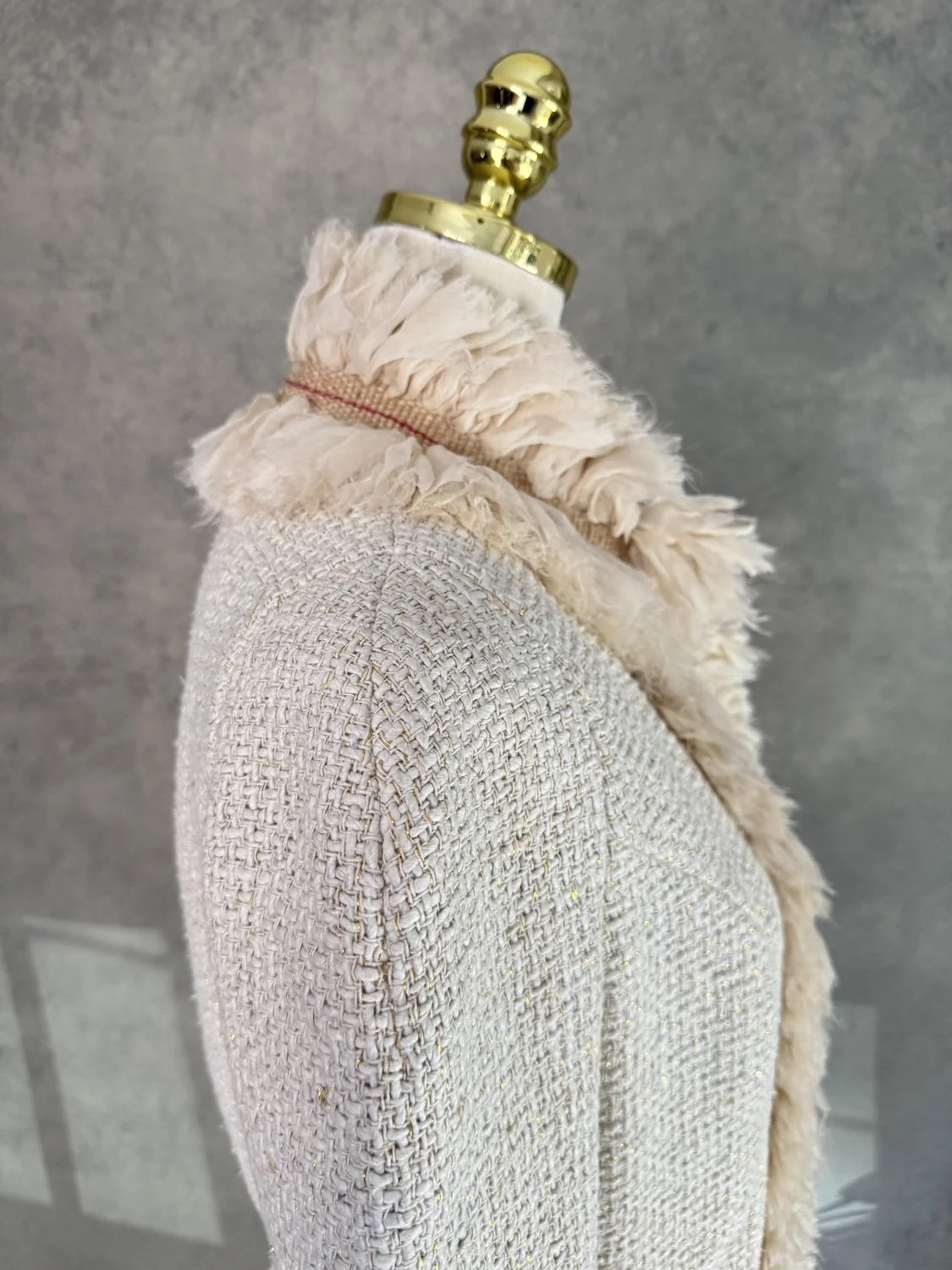 Close-up of shoulder fit and tweed weave on Jantaminiau jacket