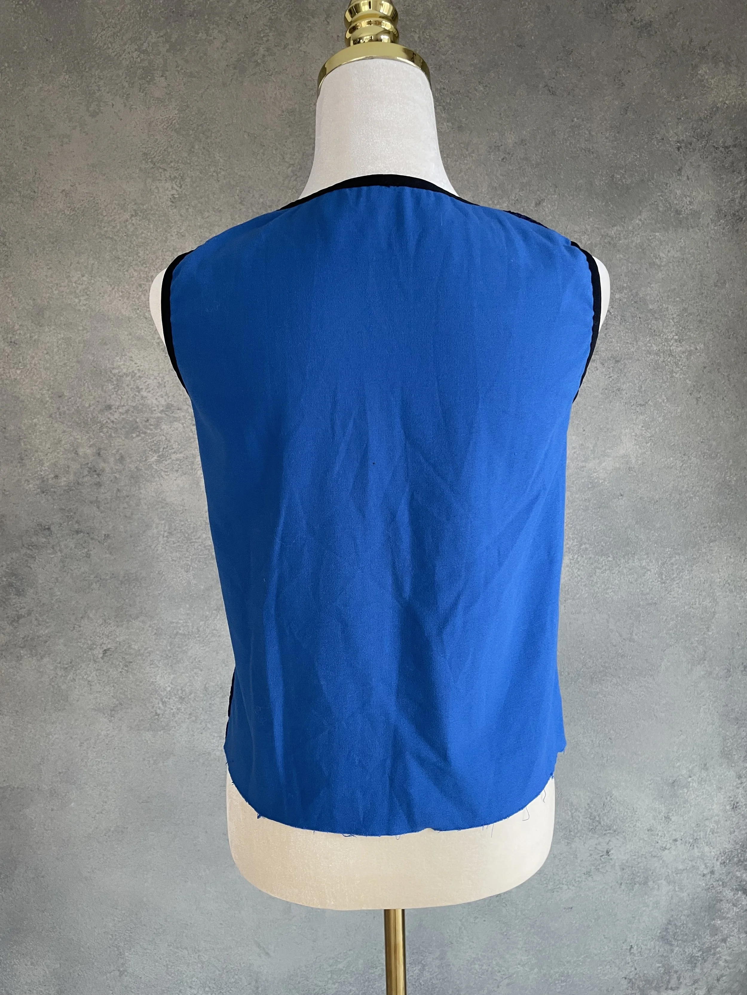 Back view of the solid royal blue Vladimir Karaleev top on a mannequin.
