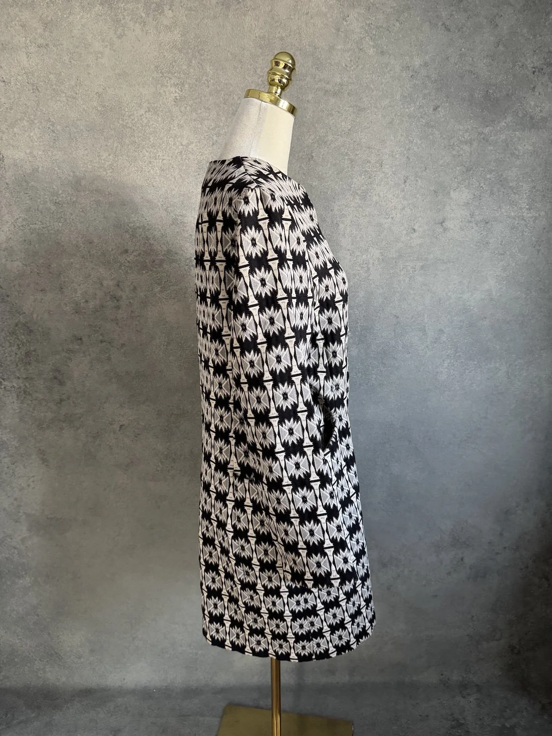 Side profile view of Hoss Intropia geometric woven coat on mannequin