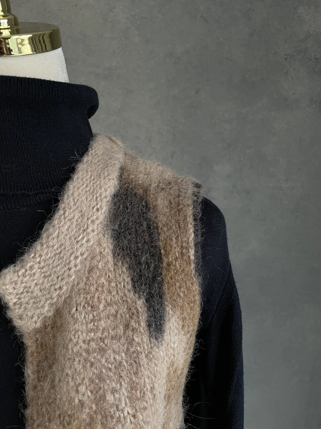 Close-up of textured knit shoulder and shawl collar of 10 Feet vest
