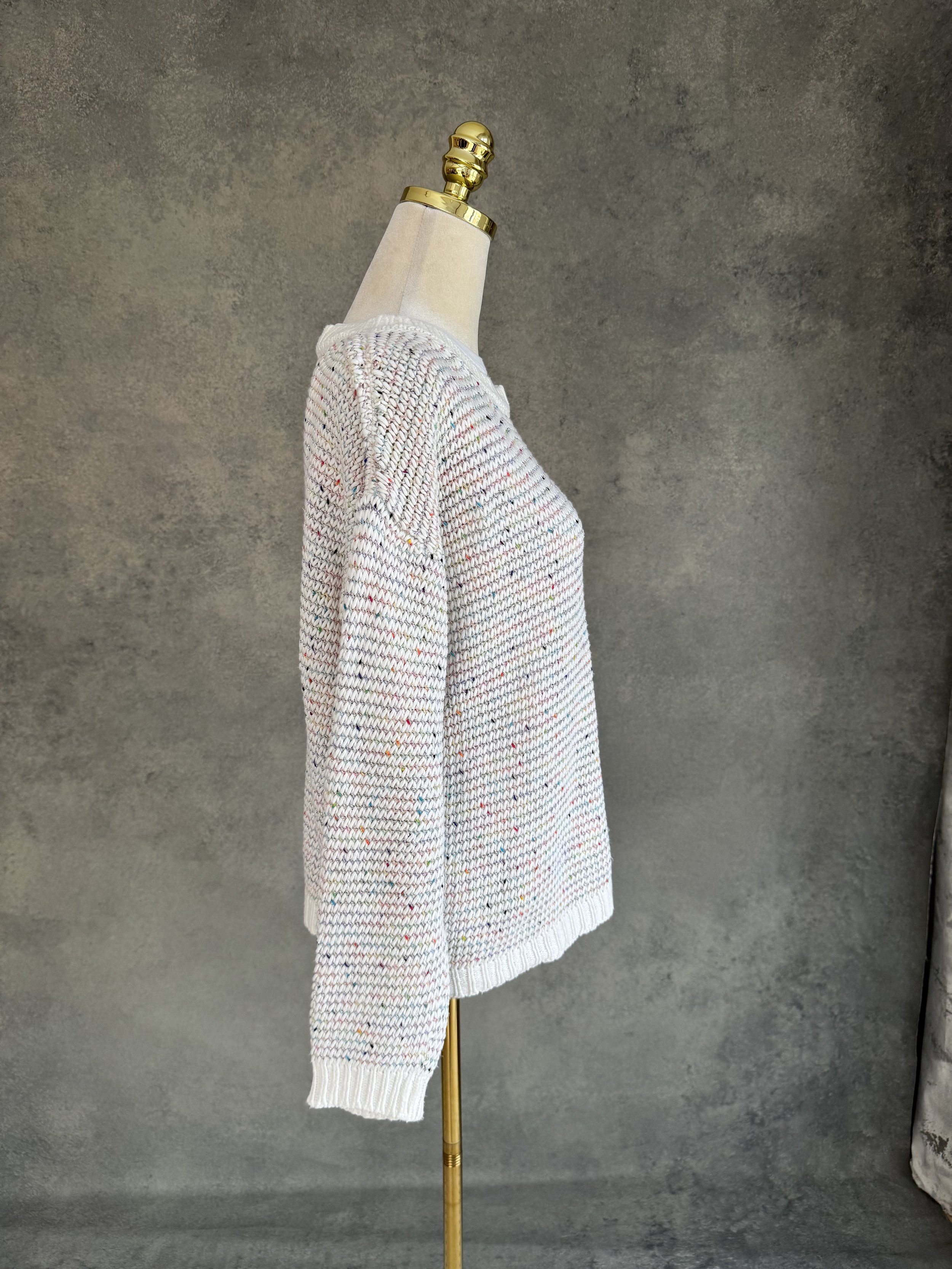 Side profile view of the SCAPA FLOW jumper on a mannequin, displaying the loose drape and comfortable long sleeves.