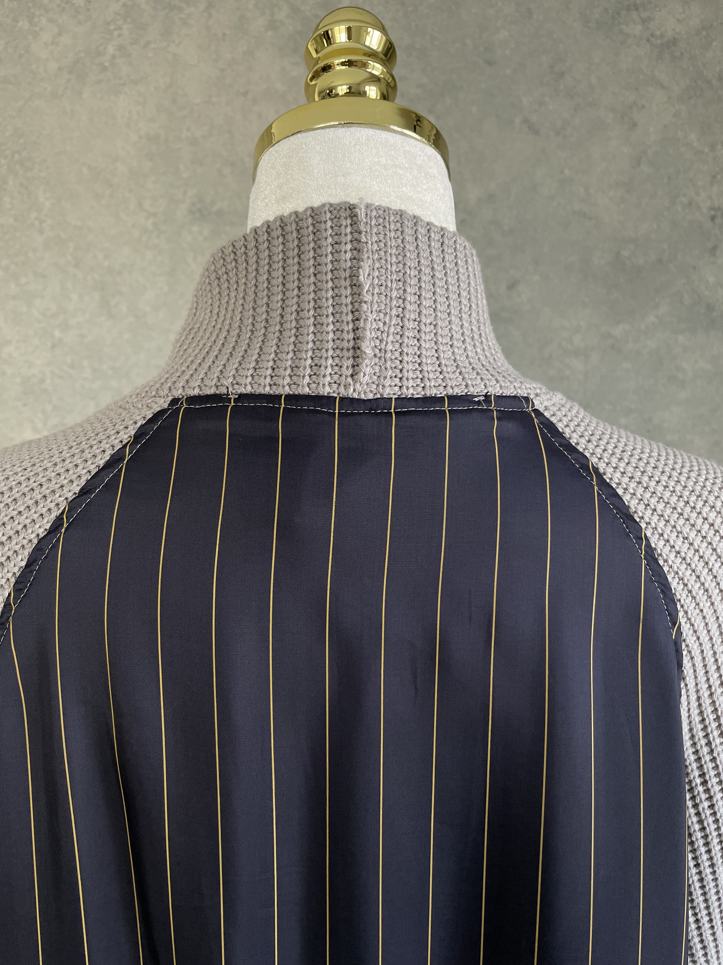 Detail of the upper back seam construction on a Vladimir Karaleev architectural knit top.