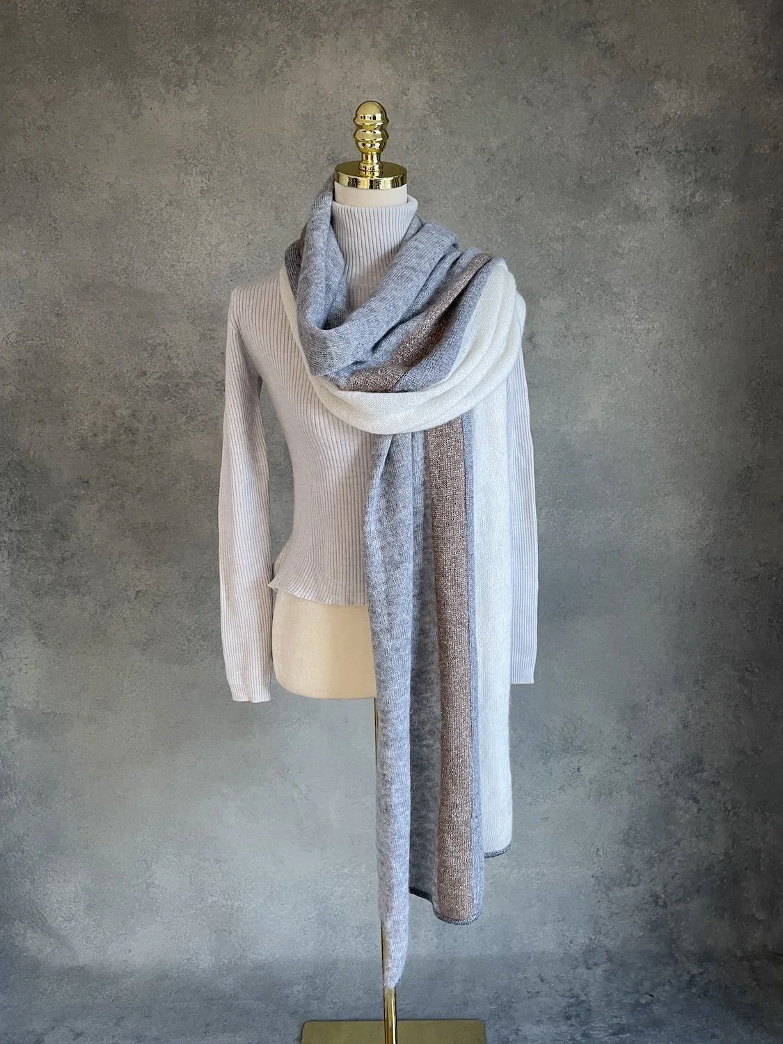 Full vertical length view of the scarf displaying the parallel cream, grey, and bronze color panels.