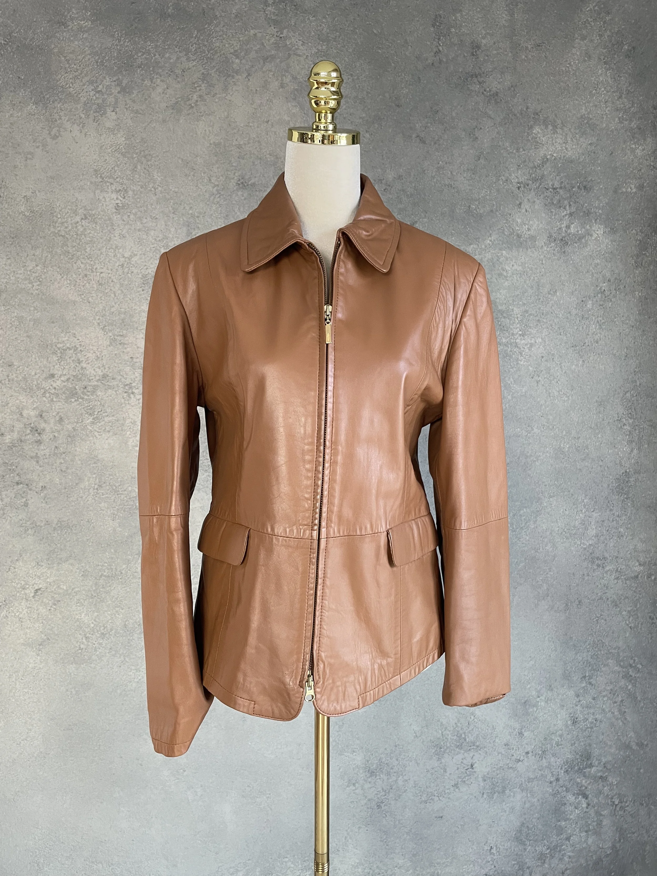 Vintage Aust cognac nappa leather jacket styled on a mannequin, highlighting the buttery-soft texture and warm tan color of the premium leather