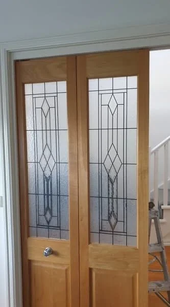 Internal timber door with stained glass.
