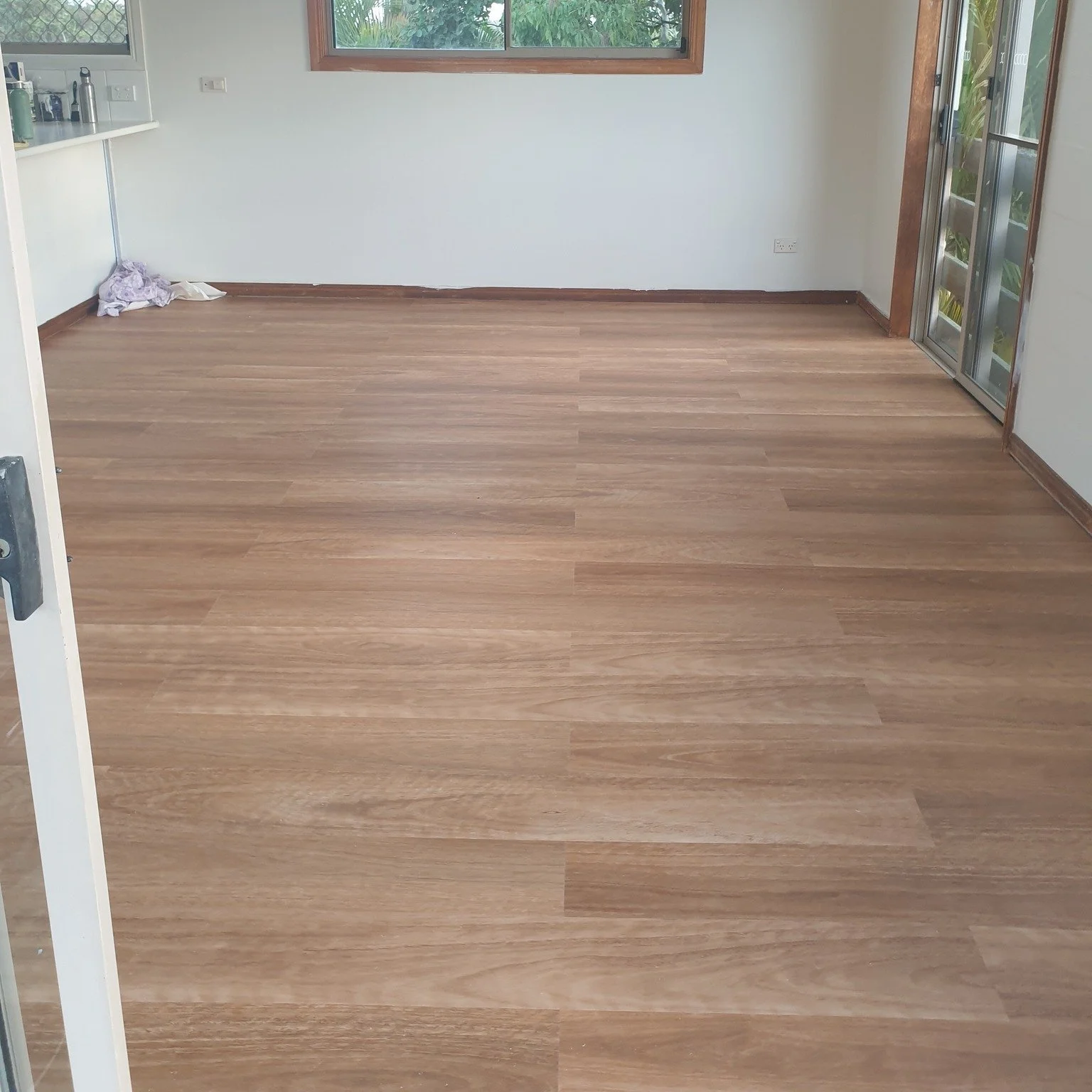 Finished and Before shots of hybrid flooring installation.  Completely changes the room.  What an upgrade! Looking for a handyman to do jobs like this, get in touch or see our website. AZI Handyman Services #handymanservices #handyman #hybridflooring