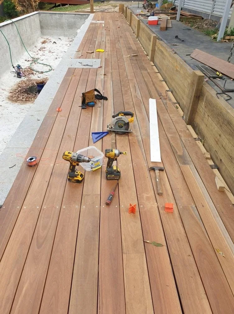 installing timber decking for small swimming  pool.