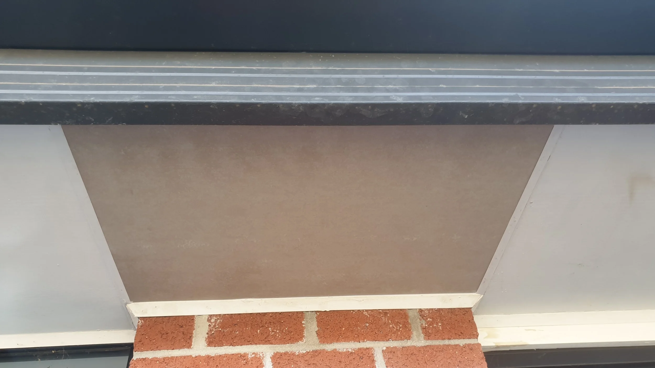 Eaves with repaired board, under side of verandah roof.
