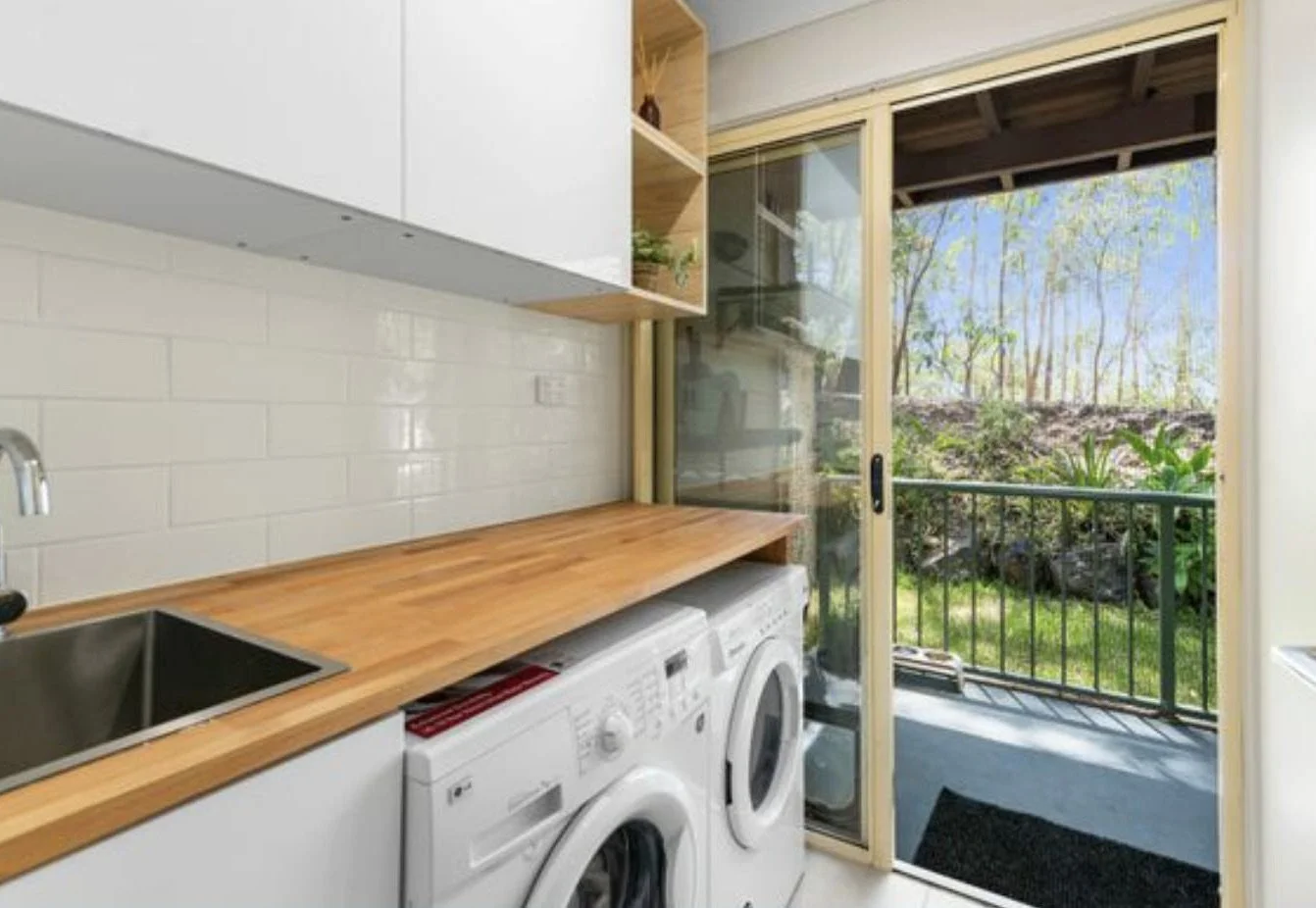 Laundry, timber benchtop, cabinetry.