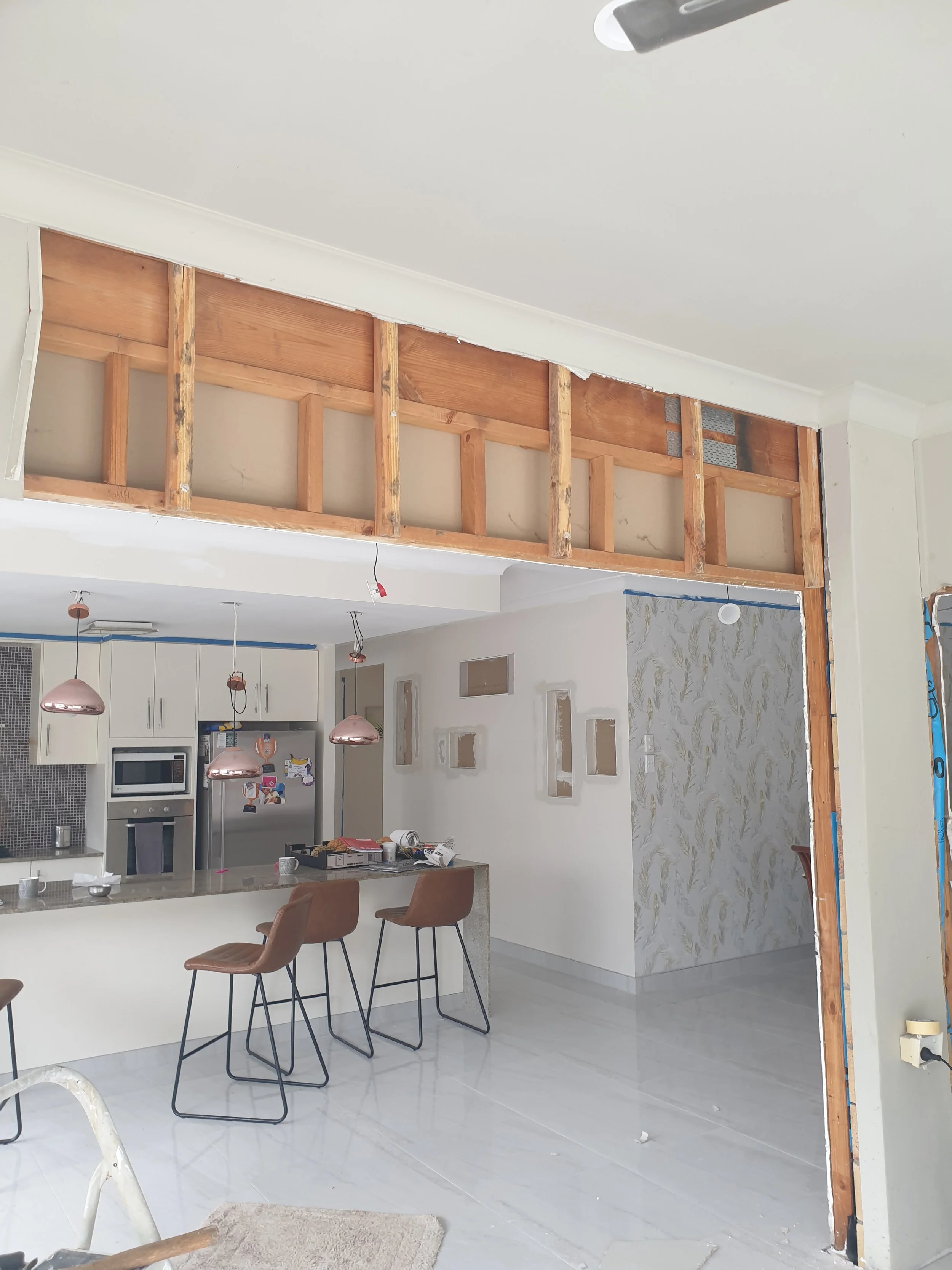 Plasterboard repairs in living and dining space.
