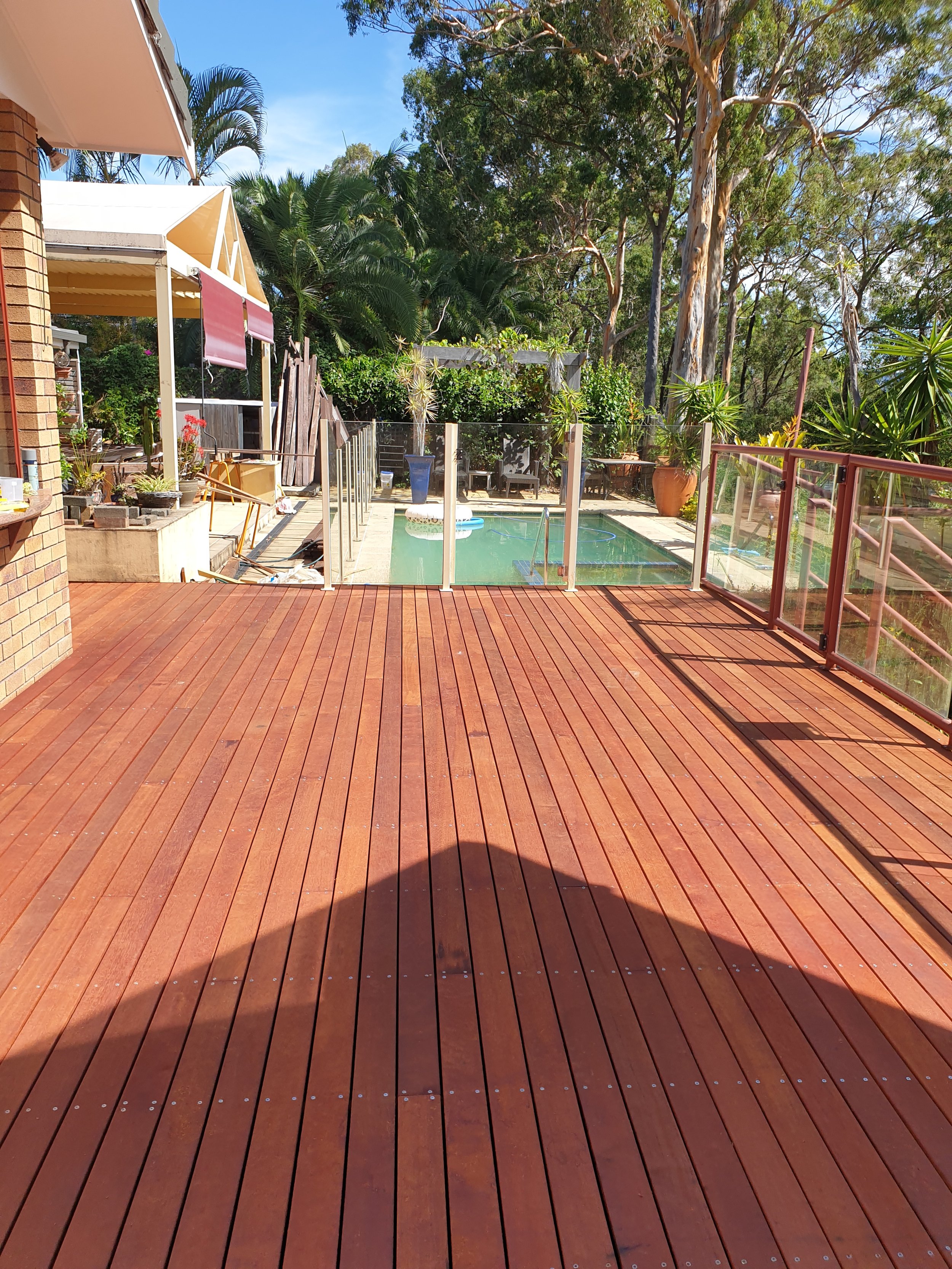 Finished wooden, timber deck, swimming pool.
