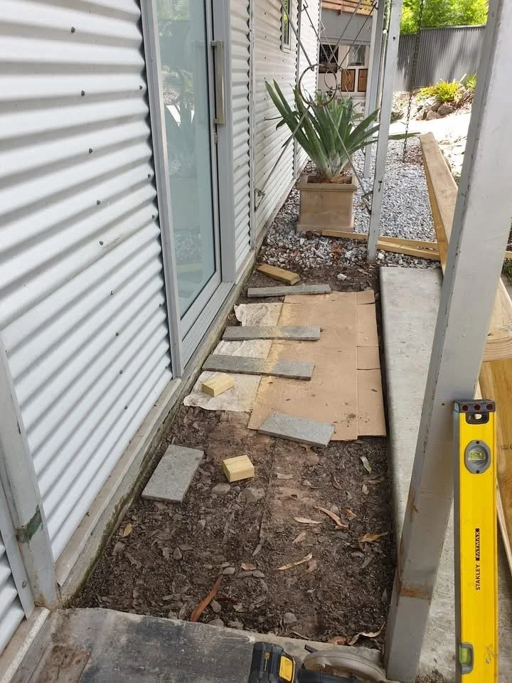 Repairs to external entrance area, corrugated iron walls.