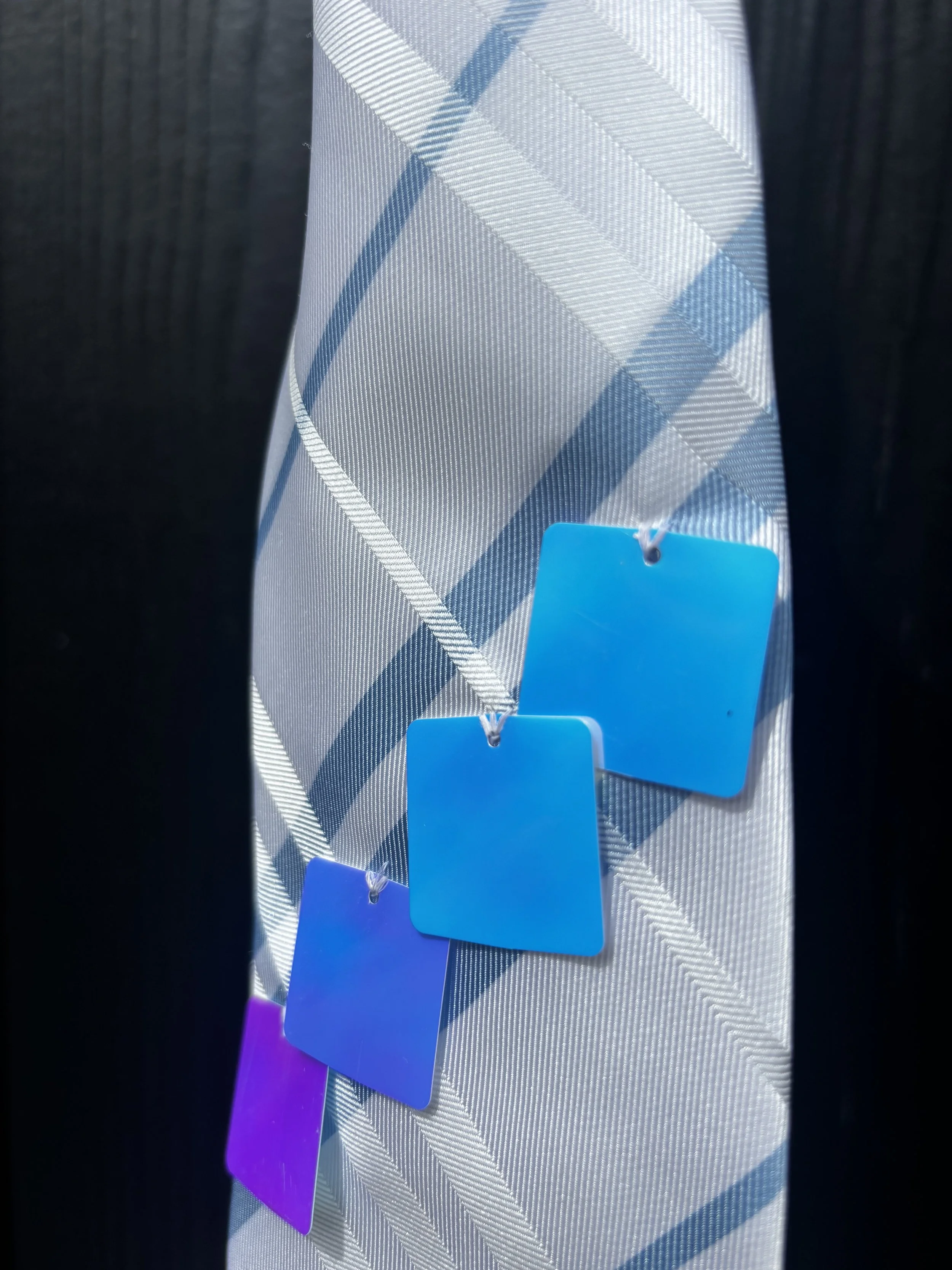 white and blue strip square. close up peg.jpeg