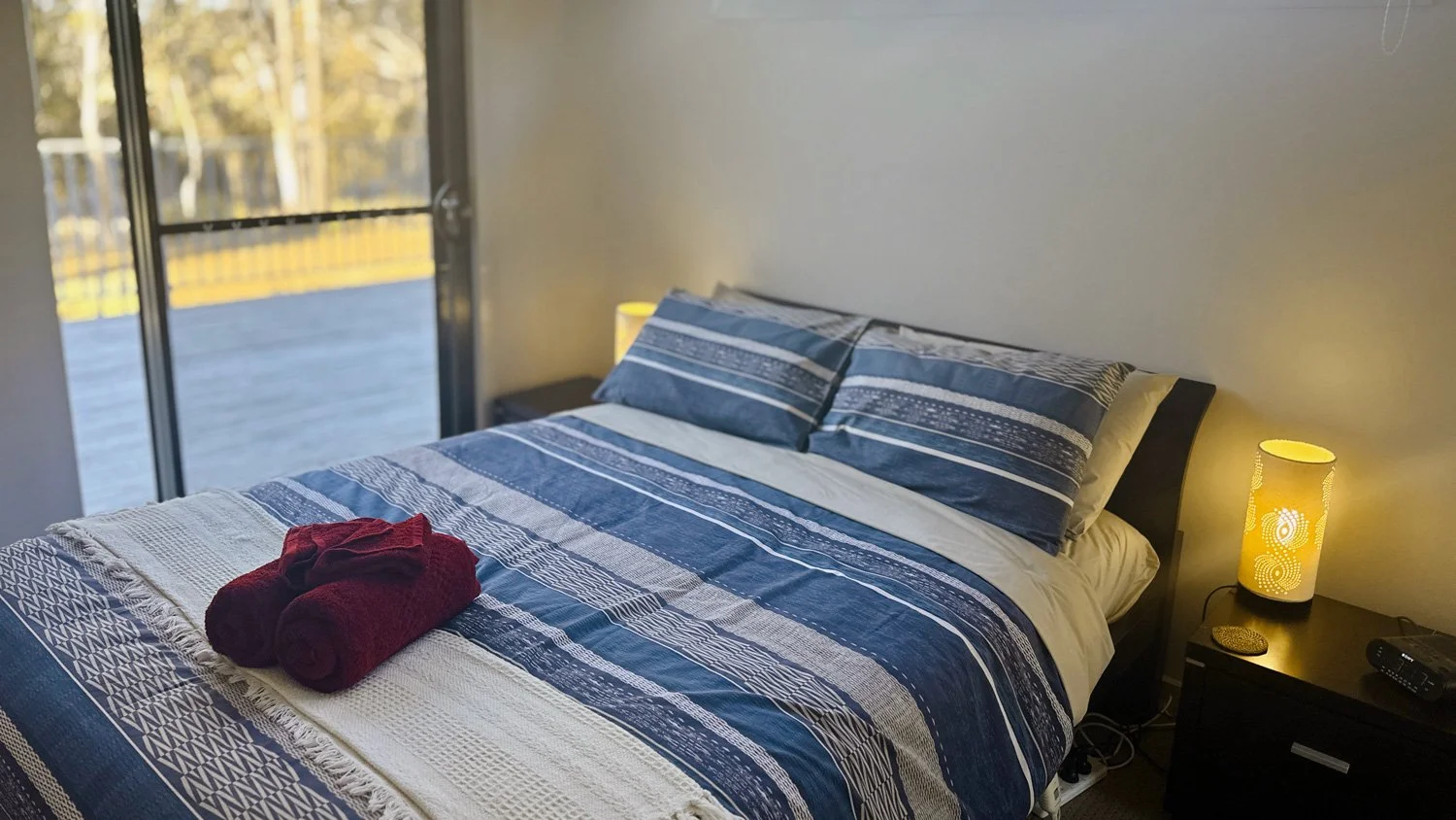 The ground floor bedrooms both have large windows and private doors onto the verandah.