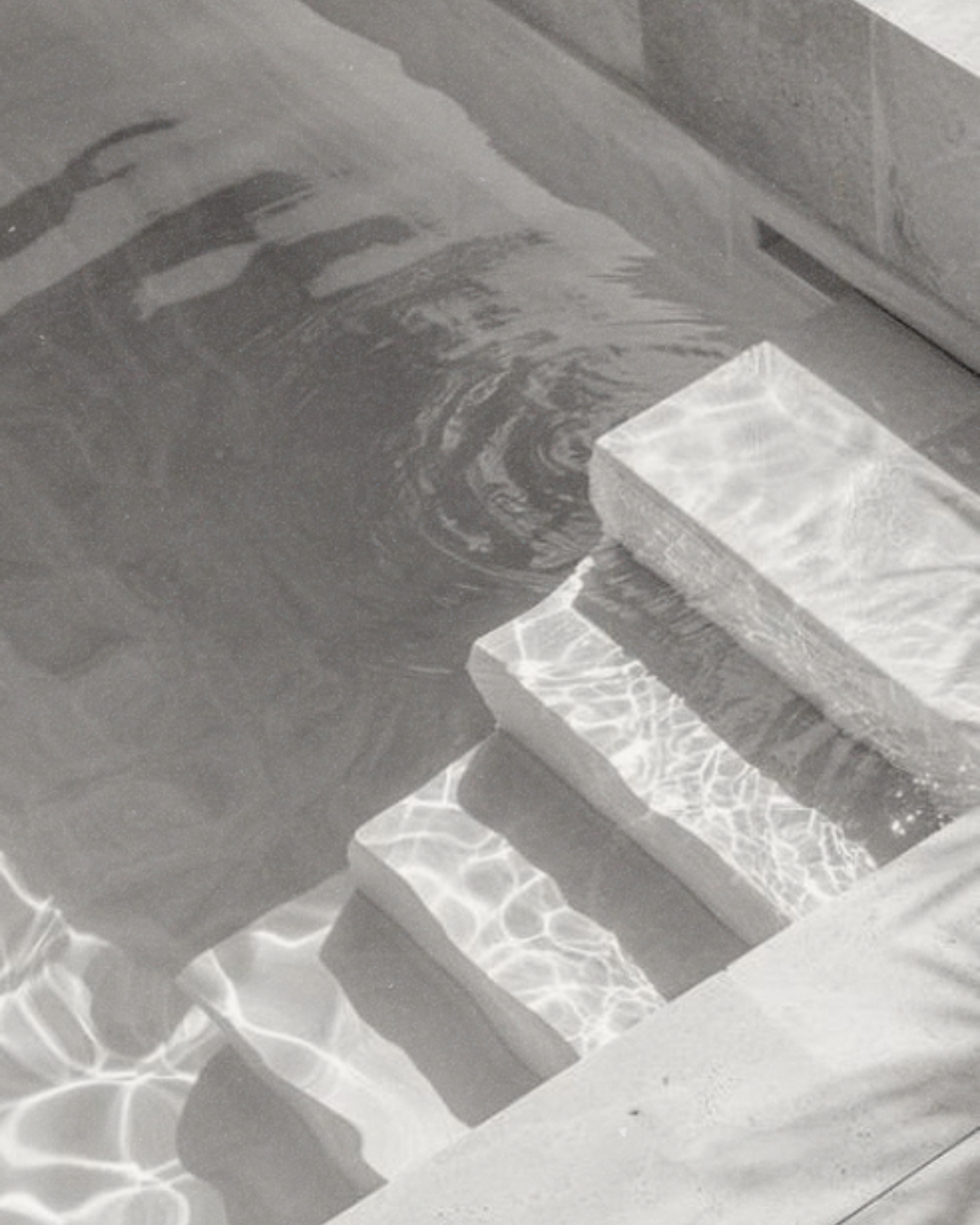 Sunlight reflections on a marble countertop creating intricate light patterns.