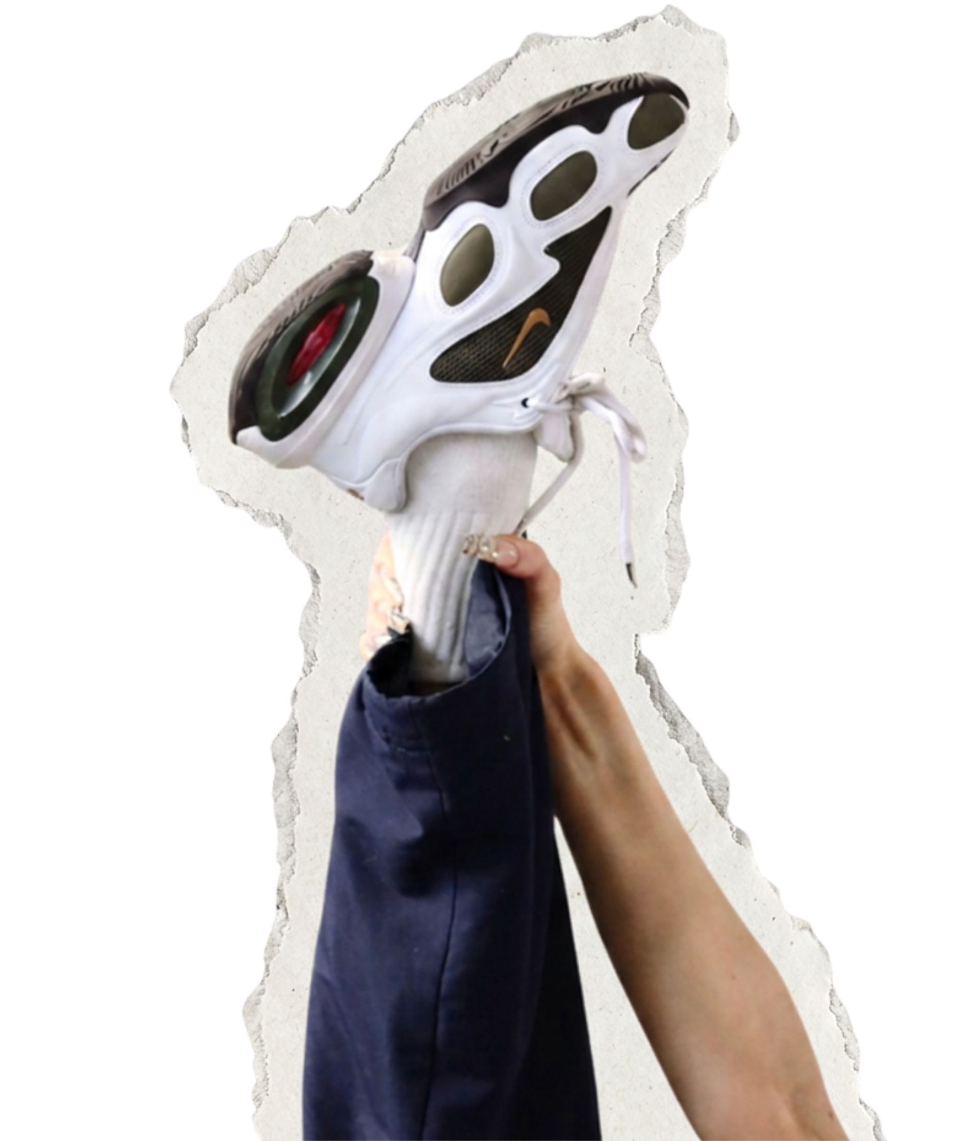 A person holding a white and black sneaker, with a brown swoosh logo, against a light background.