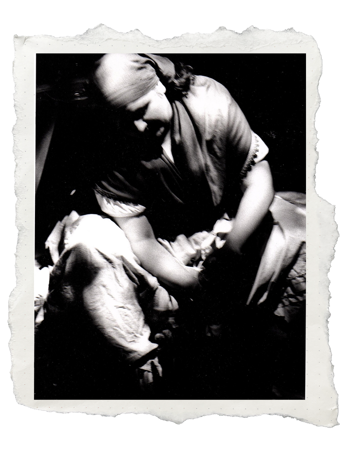 Sara Ford A black and white photo of a woman and a small child, with the woman helping the child with their shoe.