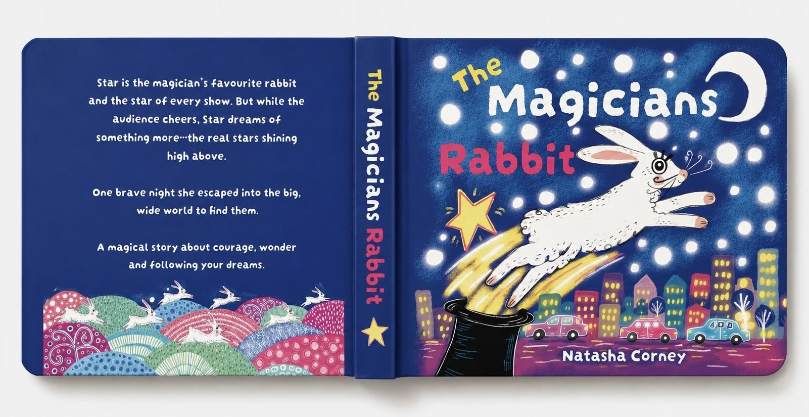 Colorful children's book titled The Magicians Rabbit by Natasha Corney, featuring a white rabbit flying out of a magic hat against a night sky with stars and a crescent moon, and a cityscape below.