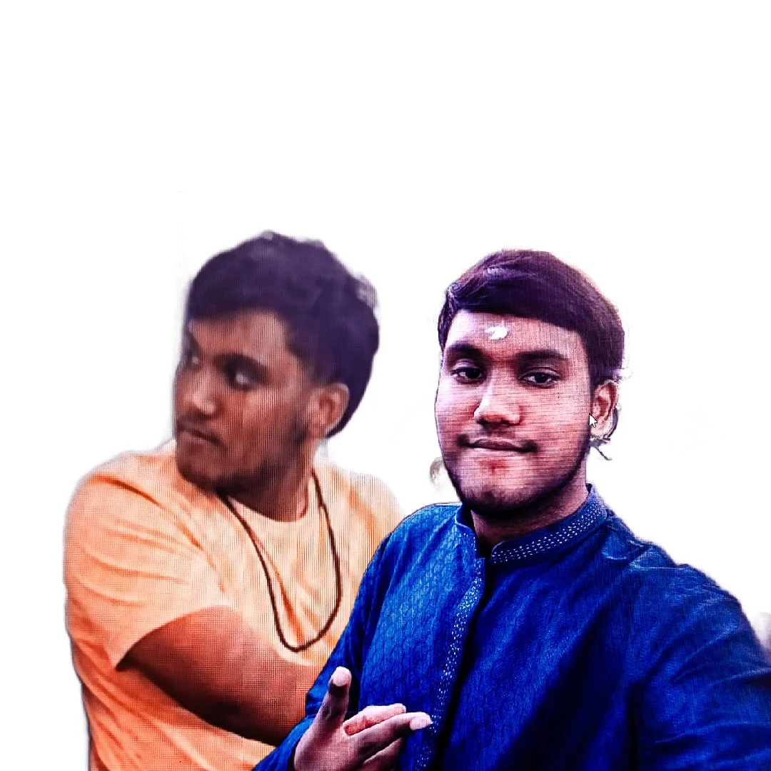 Two young men posing for a selfie against a plain white background, one in a blue traditional outfit and the other in an orange t-shirt.