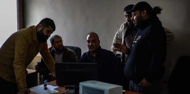 A group of Libyans reviews the desecrated remains of victims in Tarhuna to help identify loved ones. ©RYP, all rights reserved 