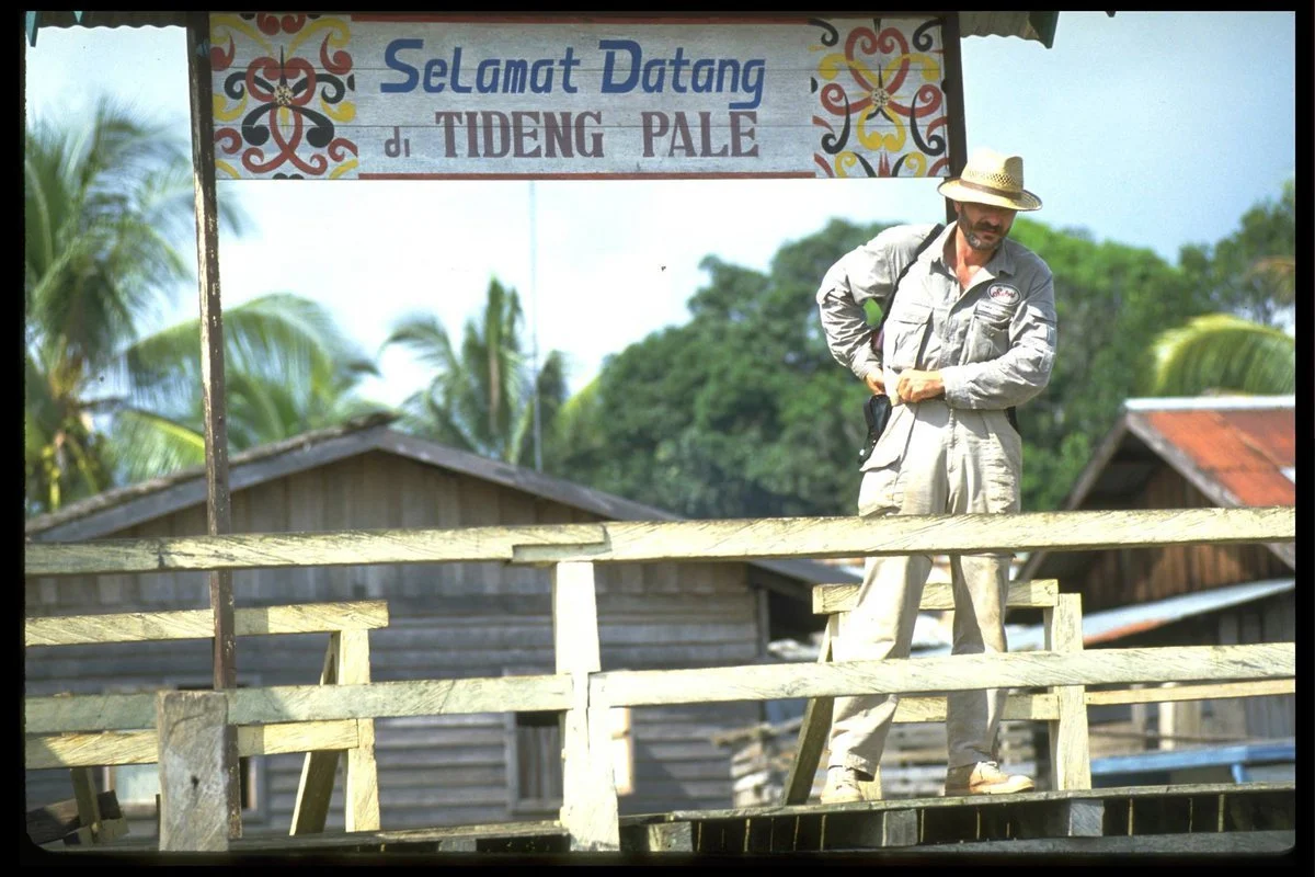 Heading down river in the blistering heat of Kalimantan, Indonesia. ©Robert Young Pelton, all rights reserved.