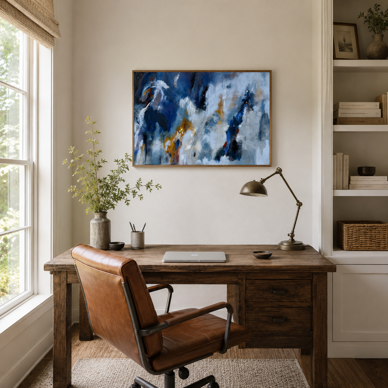 Home office with a wooden desk, leather chair, abstract oil painting by Brita Nordin on the wall