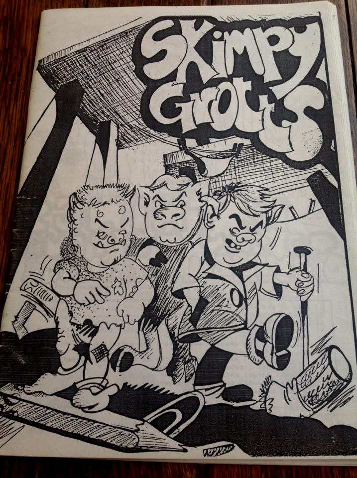 Black and white drawing of three children under a large sign that reads "Skimpy Grotto". The children are holding objects: one holding a piece of paper or leaf, another with a flashlight, and the third holding a flashlight or similar item. There are also various objects around them, including a book and tools.