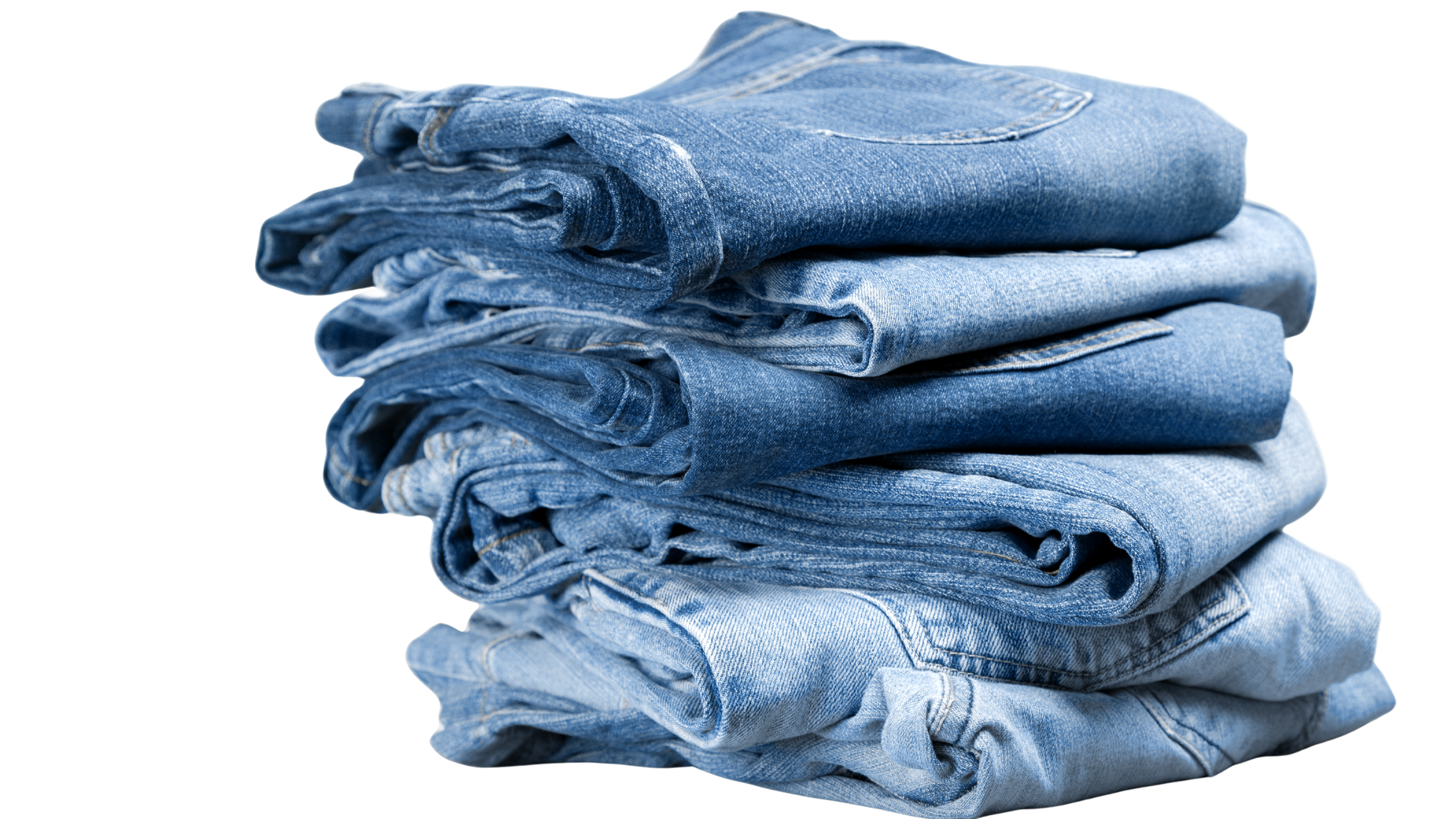 A neatly folded stack of various pairs of blue denim jeans.