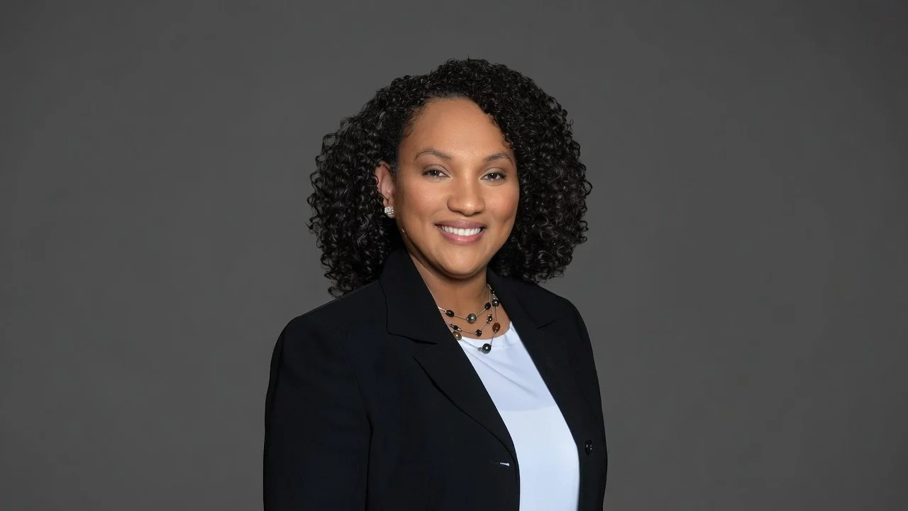 Twila Logan Former Military Officer Portrait in white blouse and black blazor.