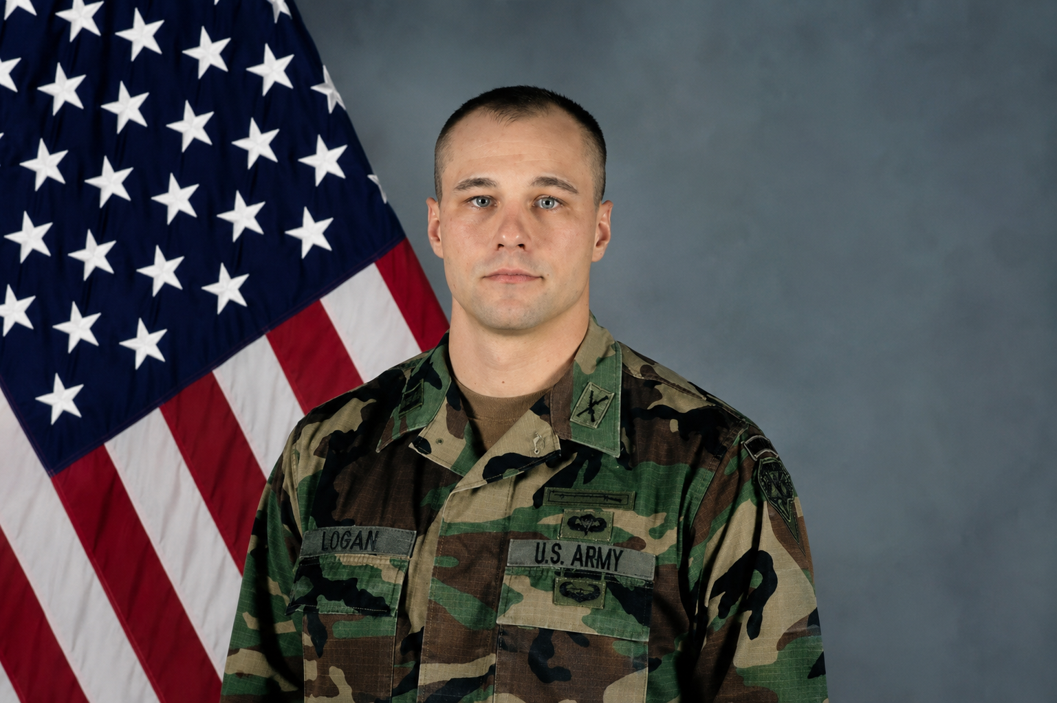 Arlyn Logan in uniform standing in front of a US flag.