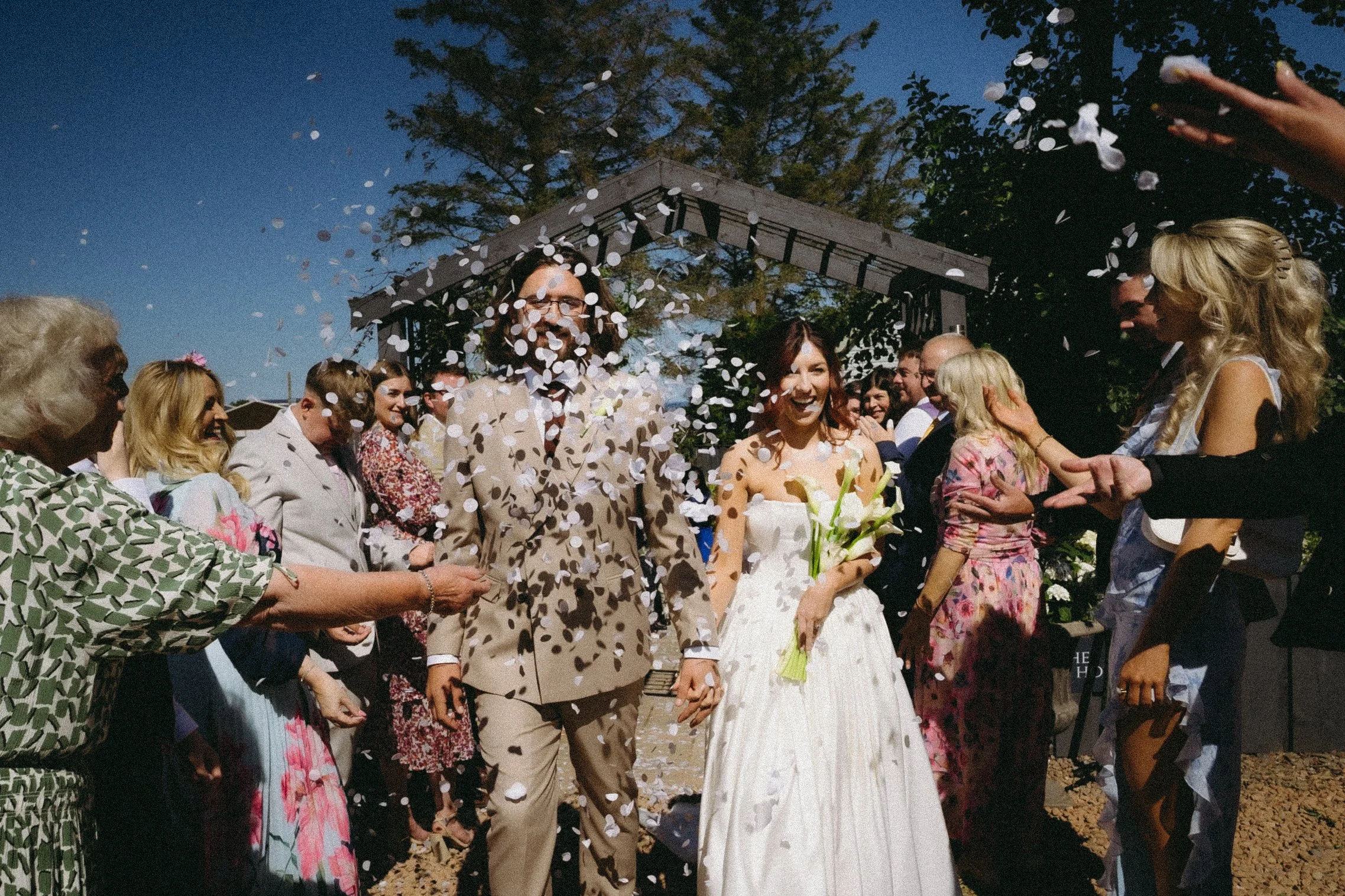 Confetti shot at wedding with happy couple