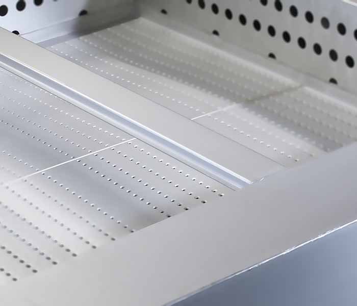 Empty metal display case with perforated shelves and a slanted front panel.