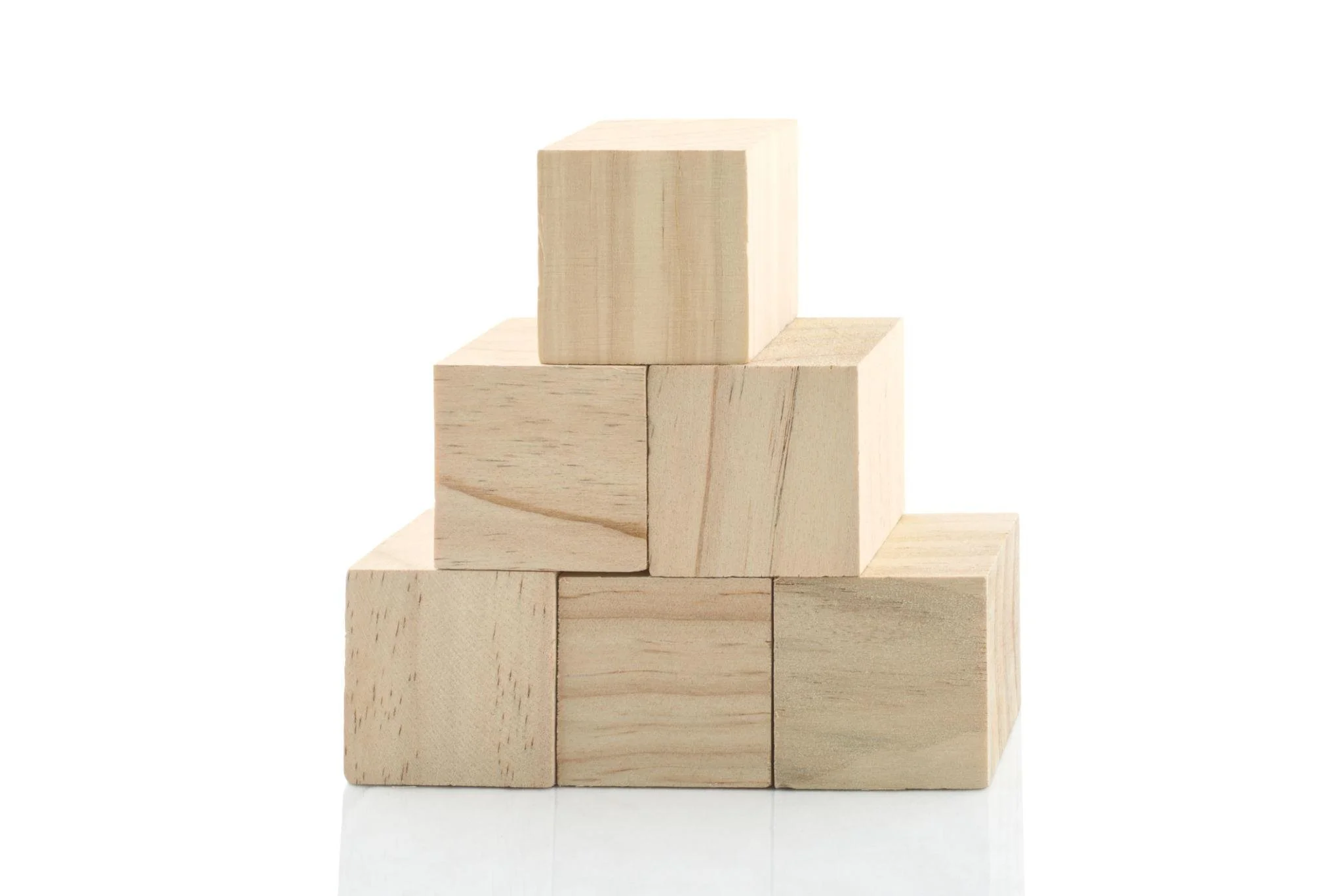 A stack of wooden blocks arranged in a pyramid shape on a white background.