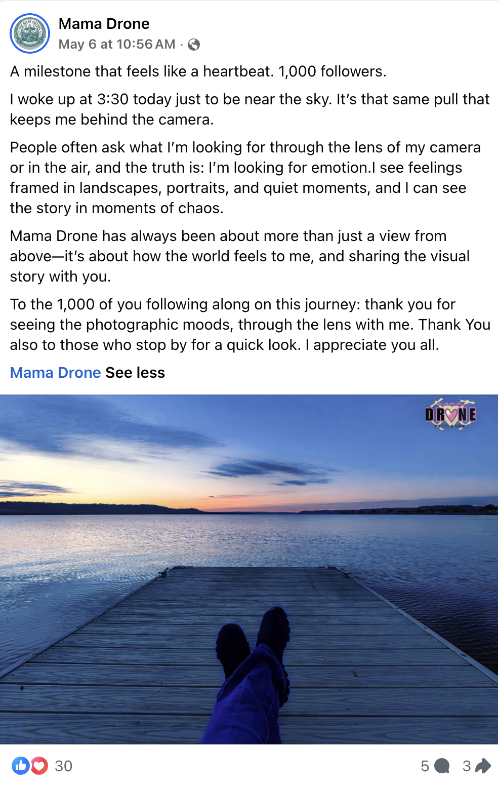 Mama Drone Facebook post with photo of a person's legs crossed on a dock, pink, blue and yellow sunset over a lake and bluffs.  Includes written caption.