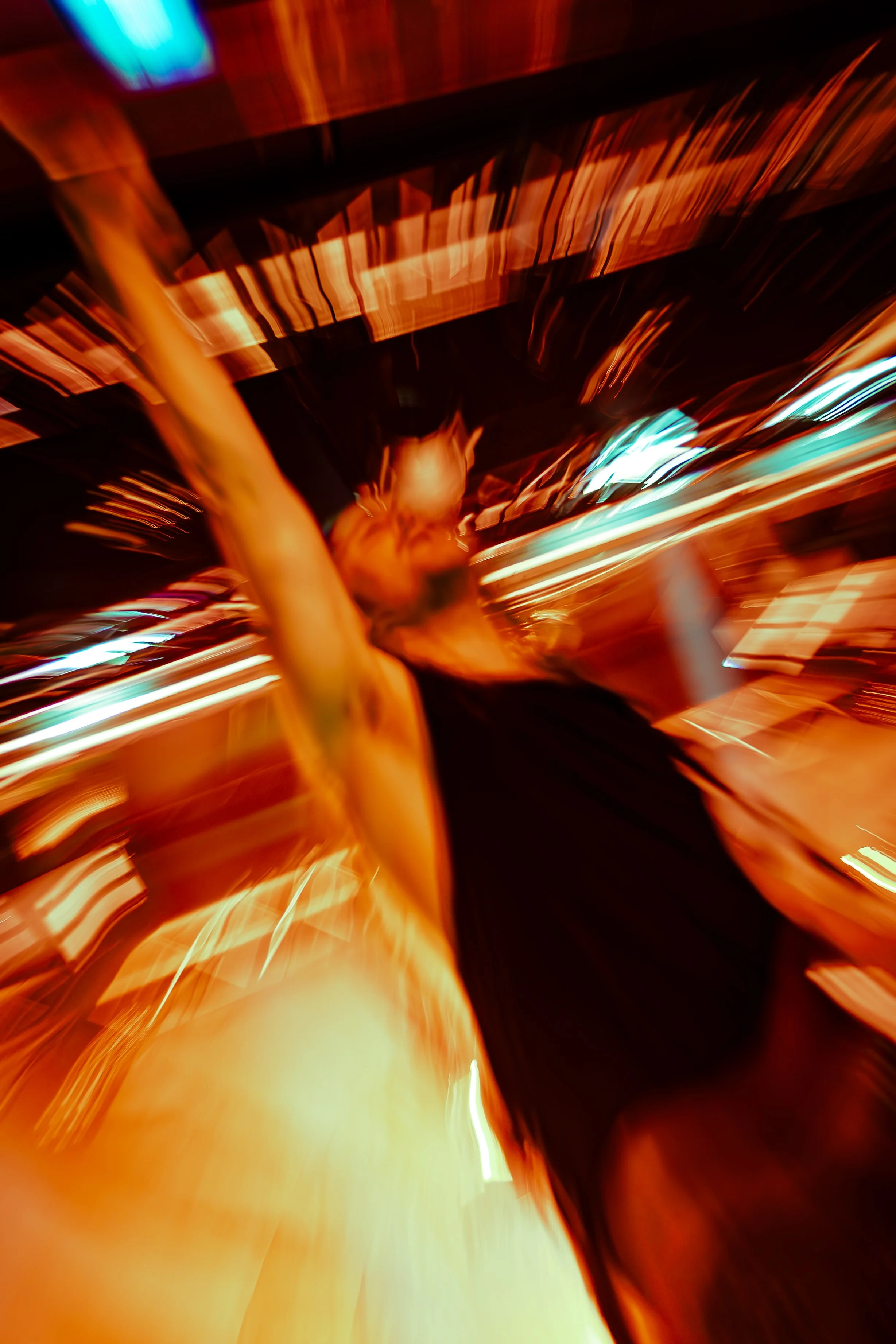 Abstract photo with streaks of bright orange, red, and yellow lights against a dark background, creating a dynamic, motion-blurred effect.