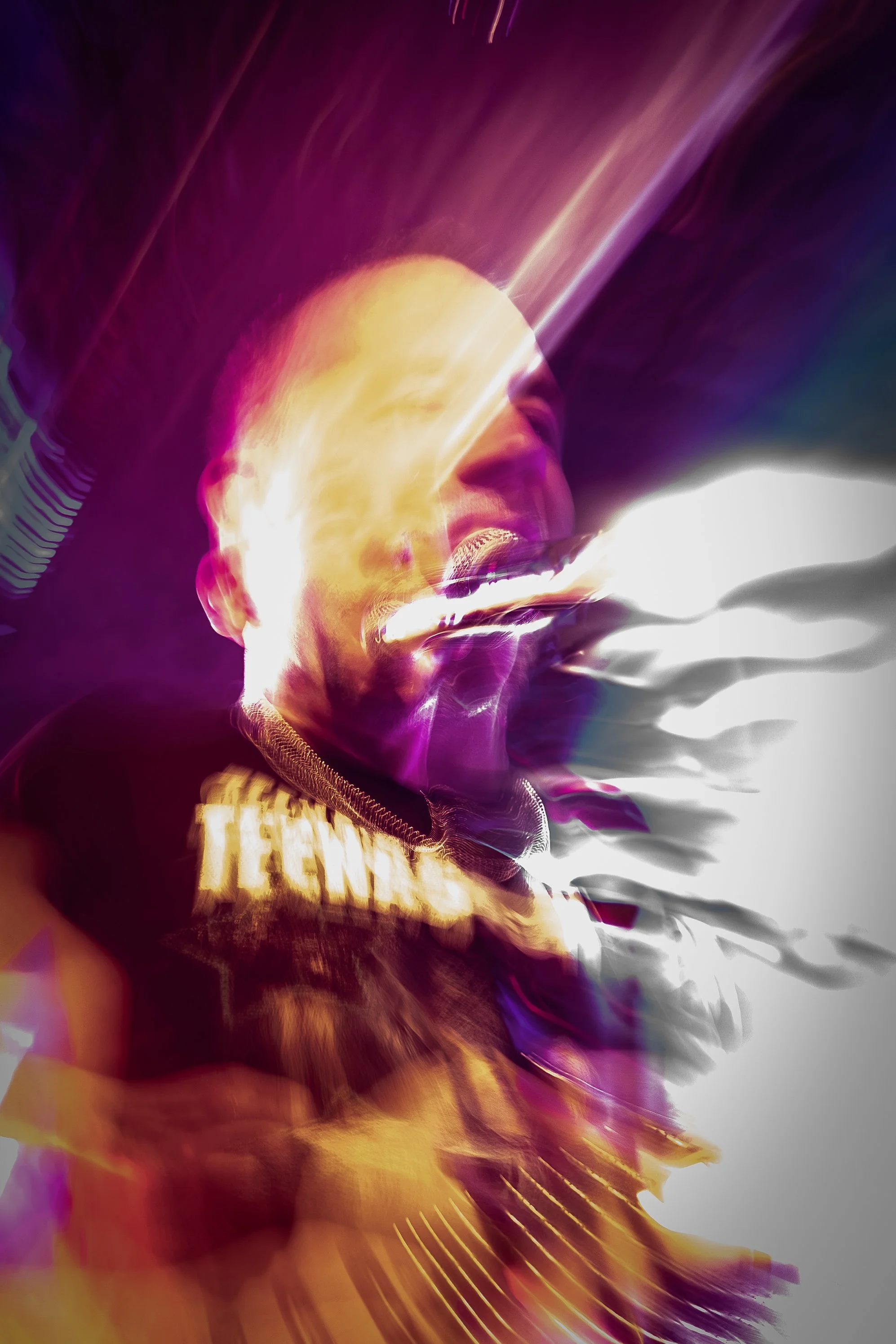 A distorted abstract image featuring vibrant purple, yellow, and white colors with a mix of light streaks and blurred elements, creating a dynamic and psychedelic visual effect.