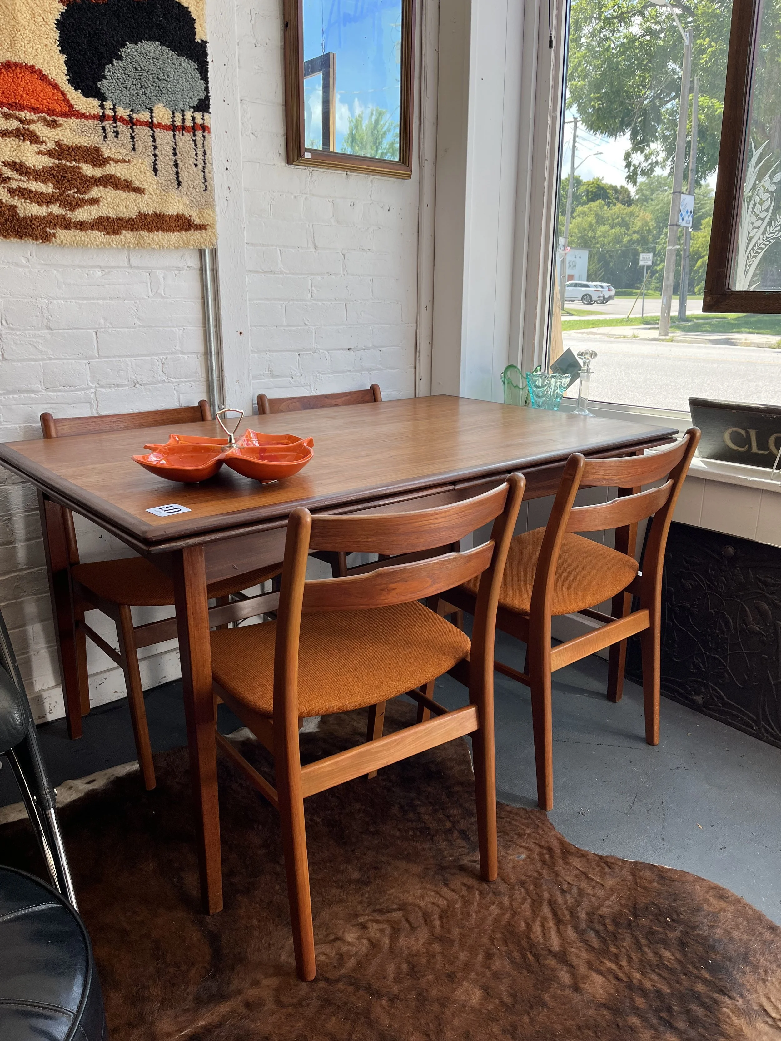 Teak extension table and set of 4 teak chairs in original upholstery.  Measures 4 ft 6" plus extensions of 2ft on either end.  ( table $595, chairs $595- set $895)