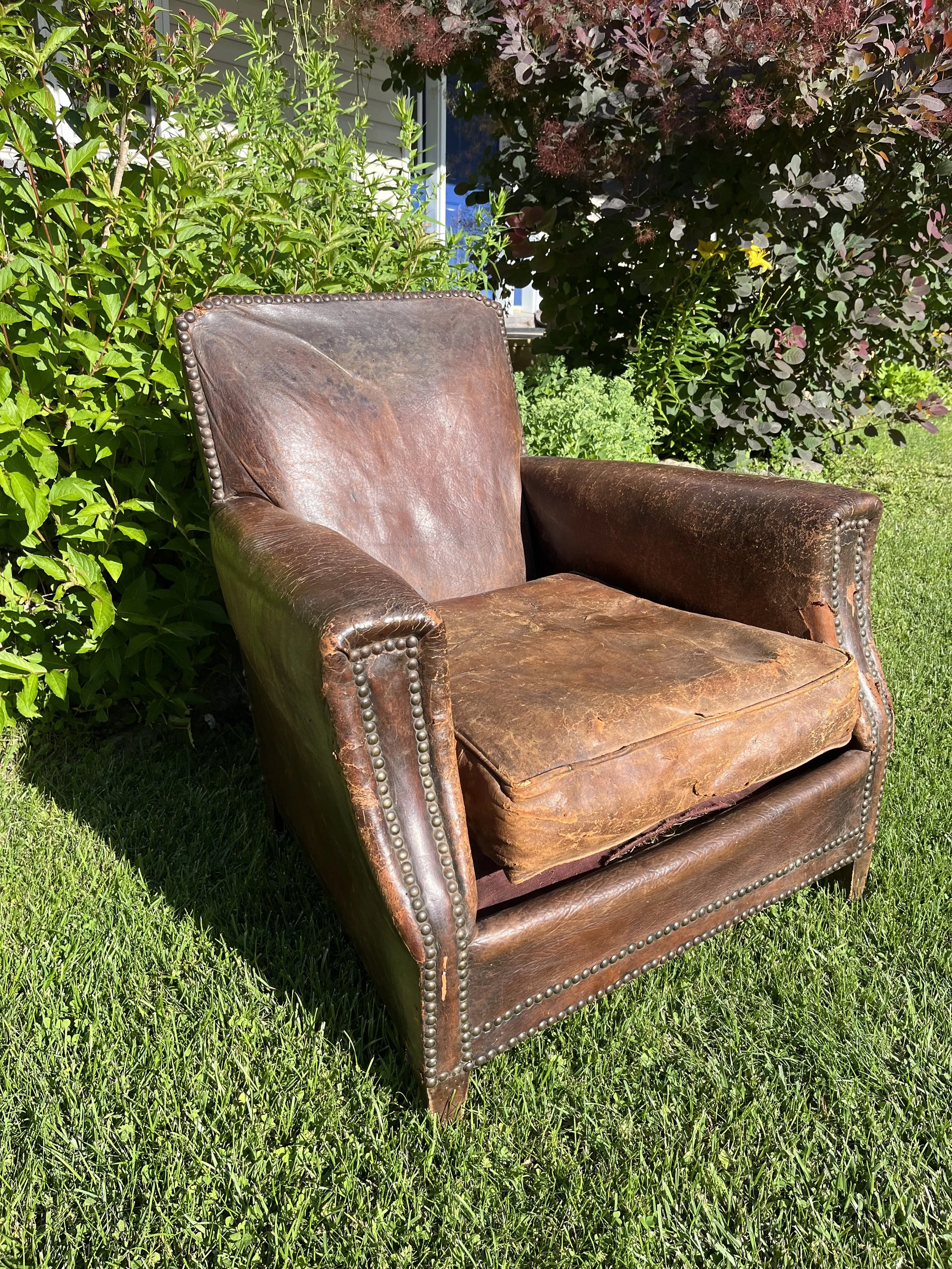 French Art Deco Club Chair circa 1920's Condition is as found.  There are tears in the leather at the back and on the cushion. But these are exceedingly rare.  Would be great for set decorators.  
