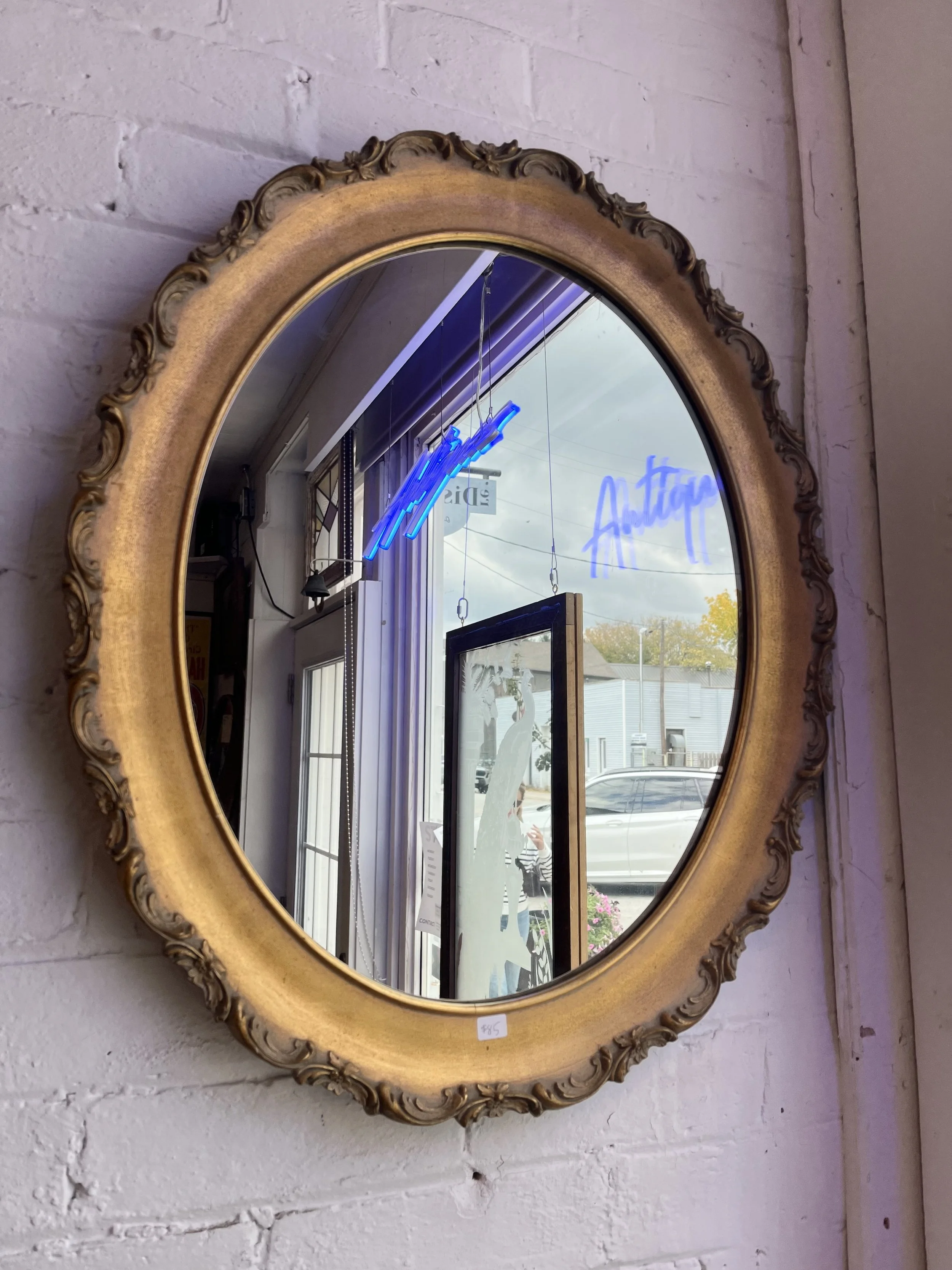 Oval gilt mirror- Measures 24" x 20".  ($85)