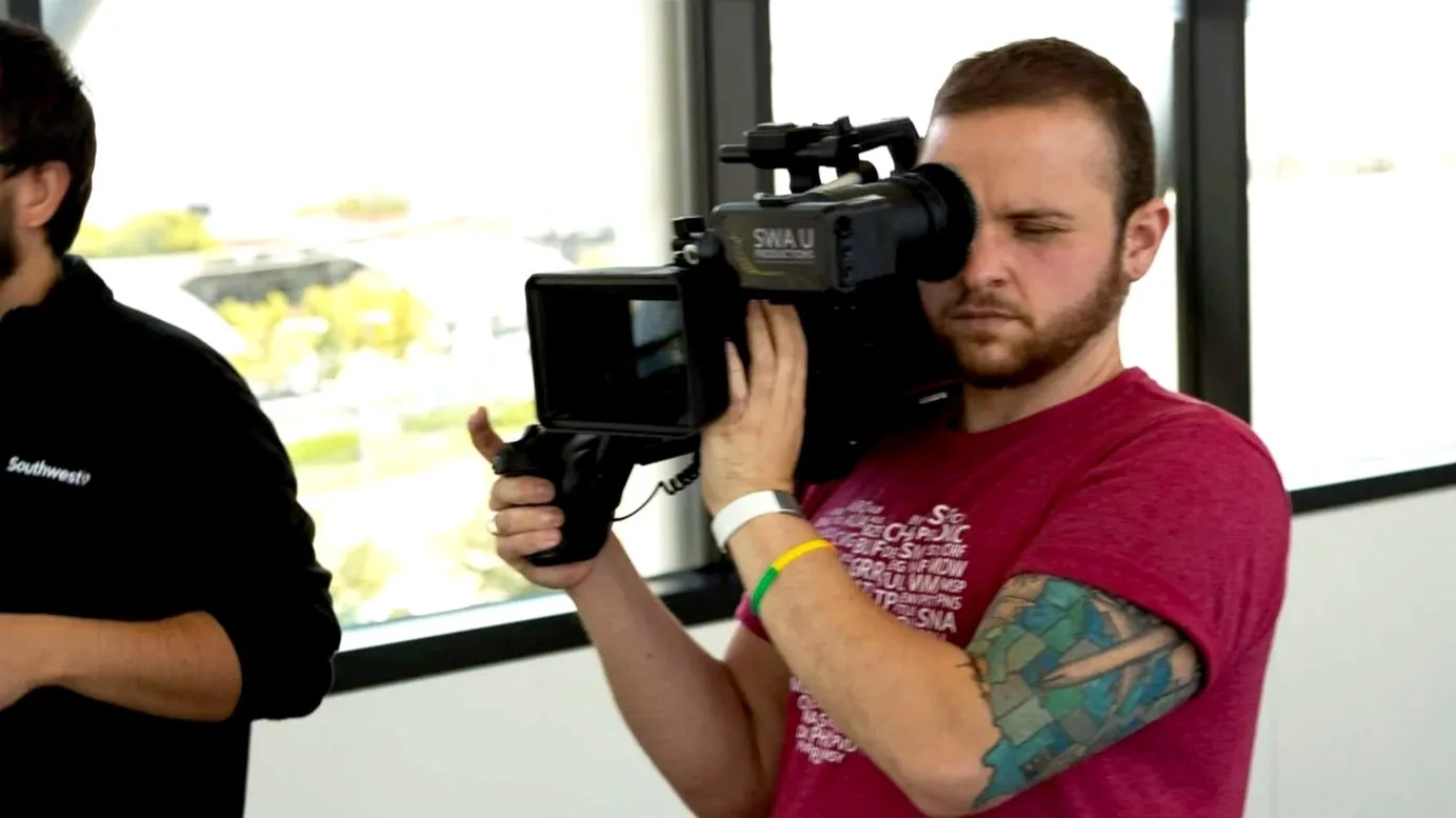 Ethan Avanzino operating a professional video camera on a production set
