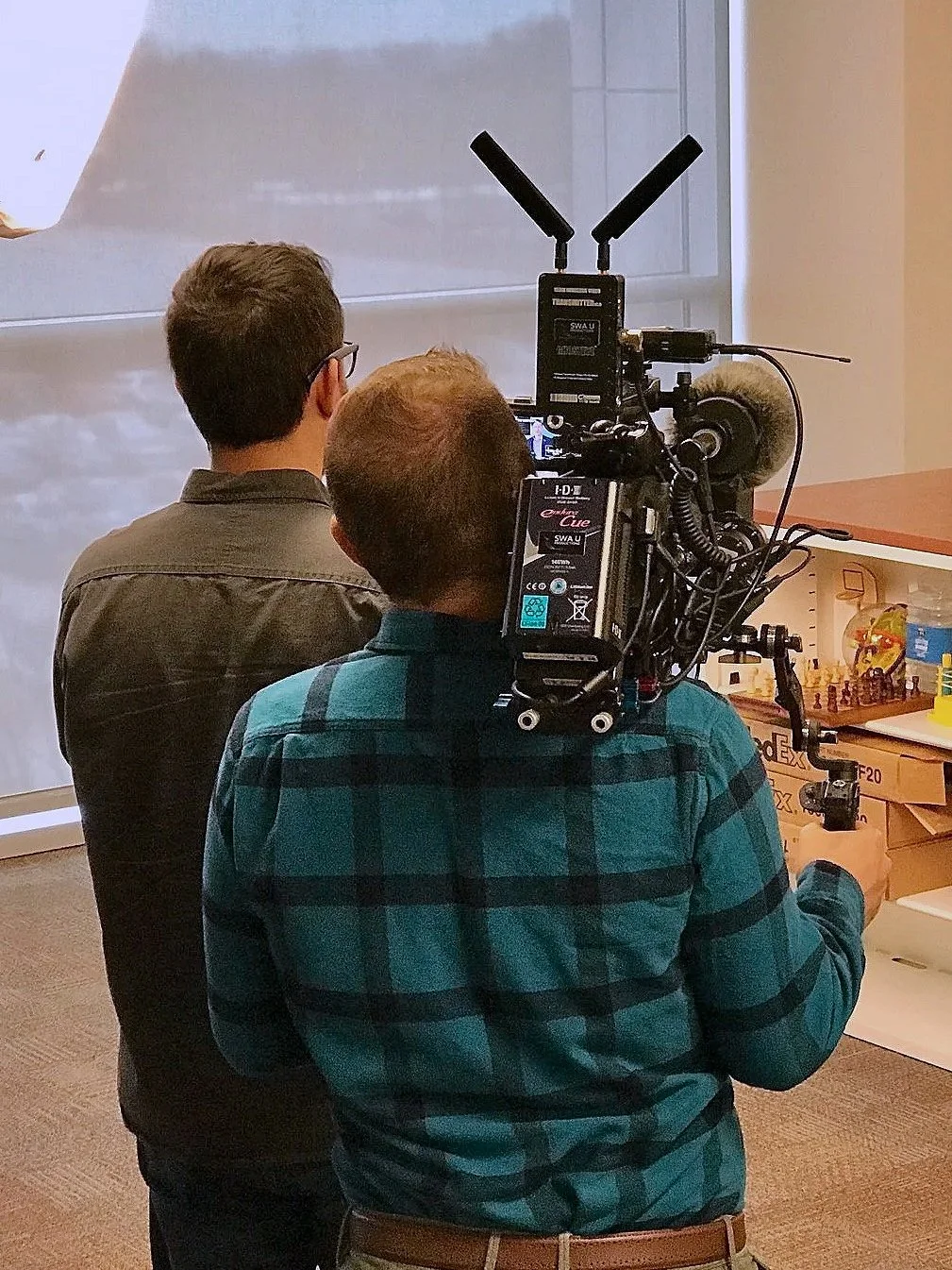Ethan Avanzino operating a cinema camera on an indoor production set