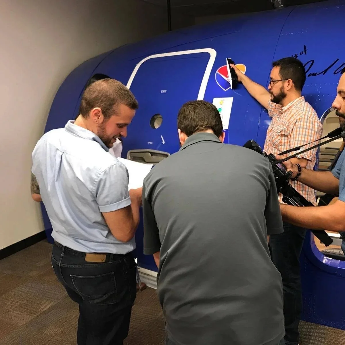 Film crew working on an aircraft production with Ethan Avanzino directing