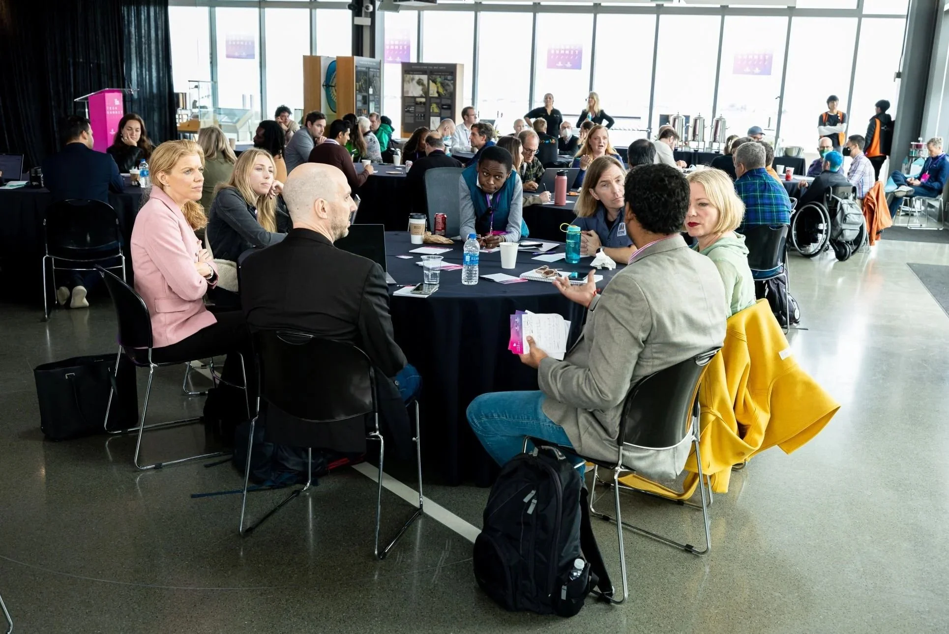 a group of accessibility professionals and leadership discussing technology and innovation