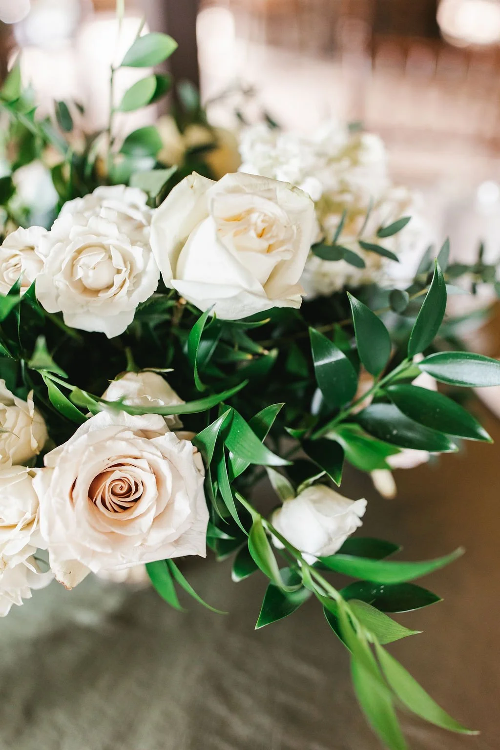 A bouquet of white roses and green foliage.