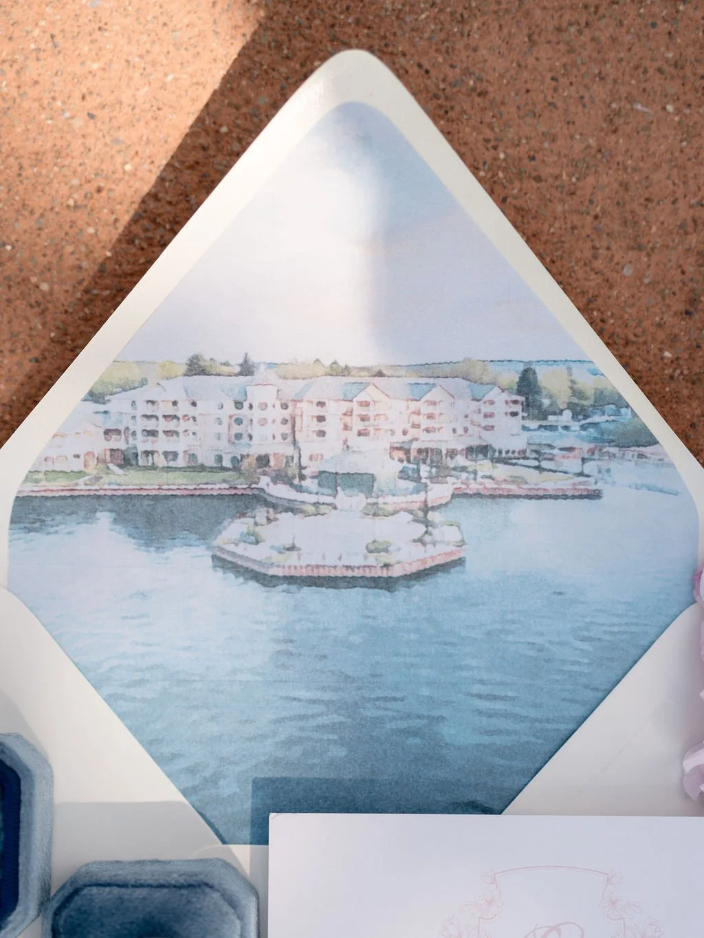 A watercolor painting of a lakeside scene with a large multi-story building, a boat dock, and greenery in the background.