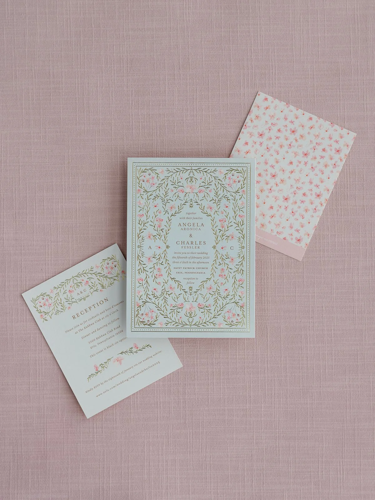Wedding invitation cards and RSVP card with floral patterns on pink textured background.