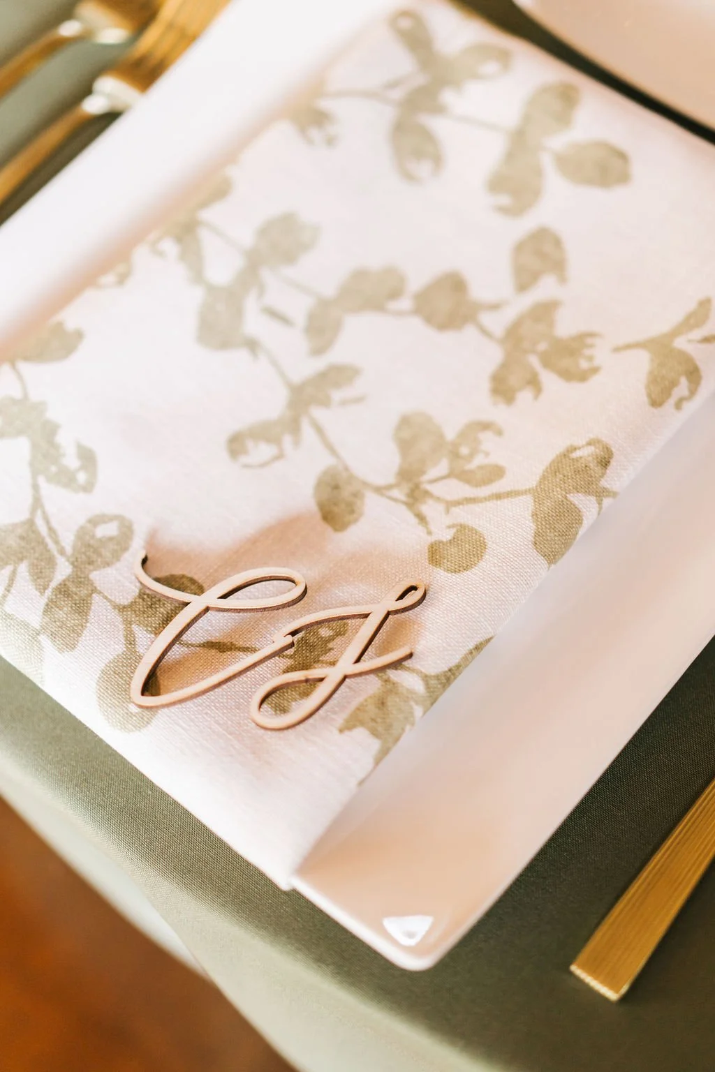 A white gift box with a floral pattern and a pink word 'Tea' on the lid, placed on a table.