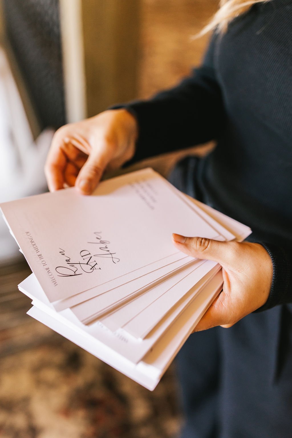 Person holding a stack of greeting cards, with the top card reading "Thank You" in cursive.
